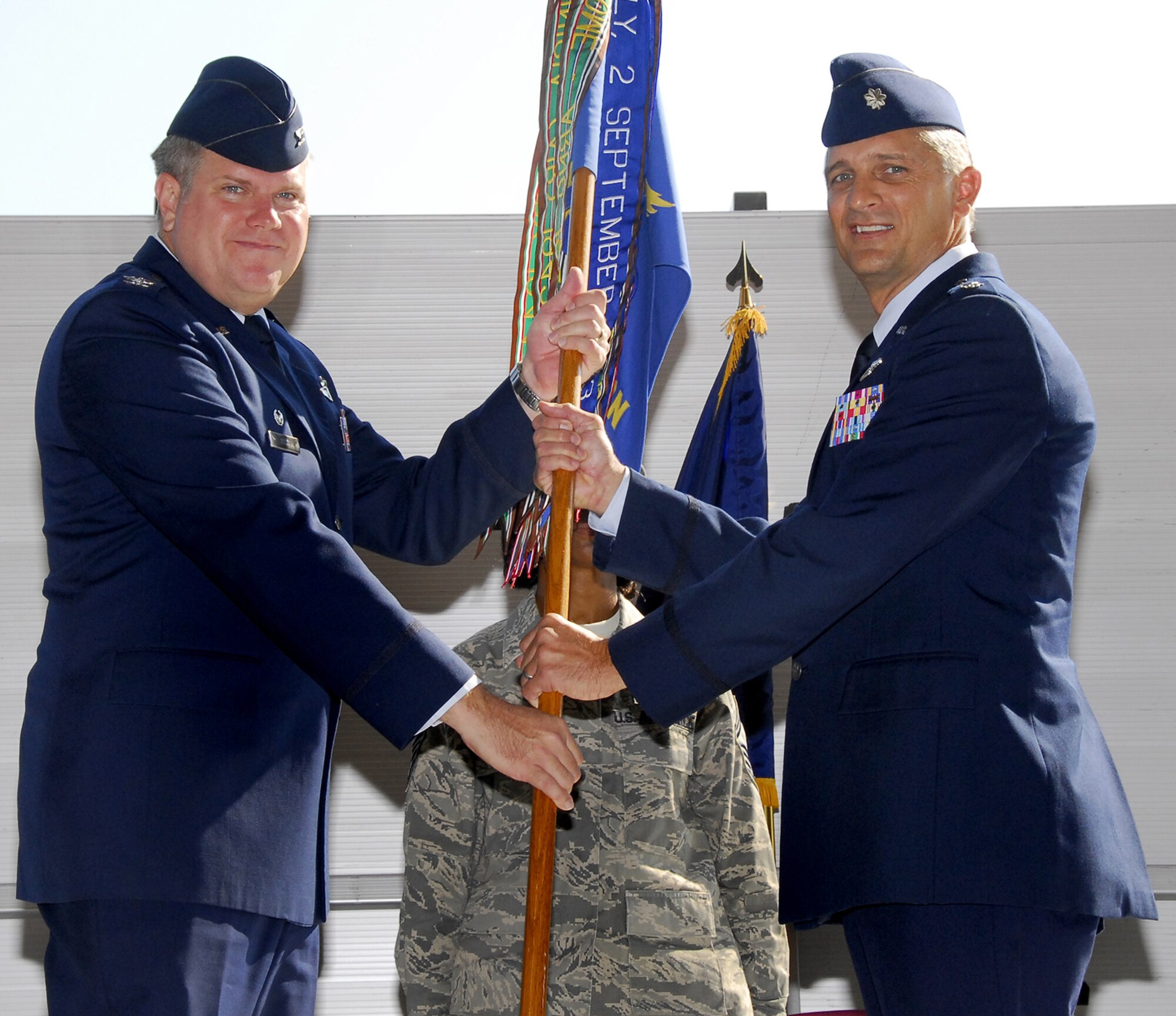 Lt. Col. Scott Thomas, right, accepts the guidon Sept. 19 from 340th Flying Training Group Commander Col. Terry Ross during a the 97th Flying Training Squadron's change of command ceremony. Lt. Col. Bo McGowan relinqished command of the reserve squadron. The squadron provides instructor pilots to the 80th Flying Training Wing's Euro-NATO Joint Jet Pilot Training Program. (U.S. Air Force photo/Harry Tonemah)