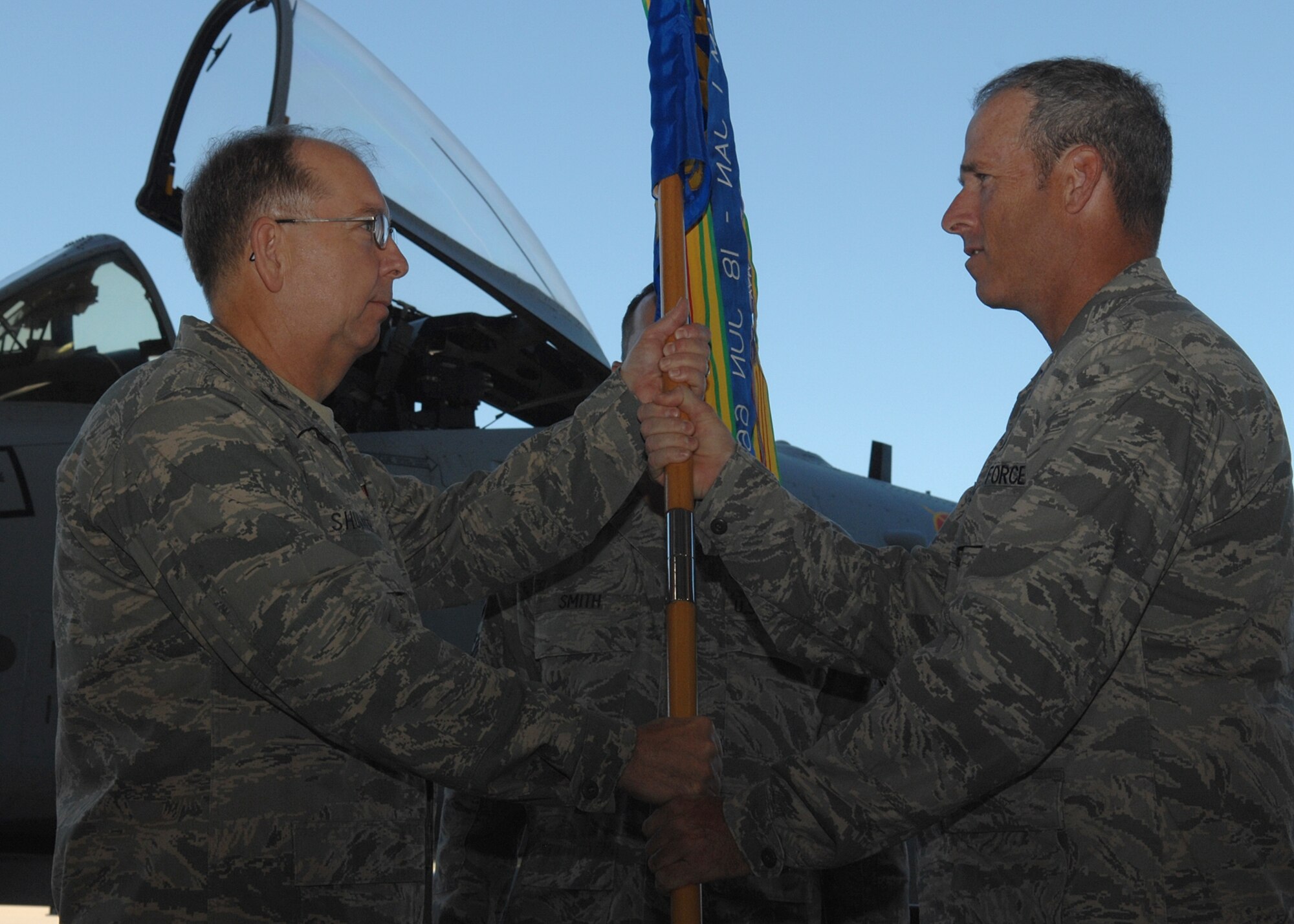 Maj. Michael Allison (right) receives the 355th Aircraft Maintenance Squadron guidon from the Col. Dennis Shumaker, 355th Maintenance Group commander, during a change of command ceremony here Sept 12. Major Allison assumed command of the 355th AMXS after serving in the Theater Security Cooperation, 12th Air Force (AF Southern). (U.S. Air Force Base photo by Senior Airman Jacqueline Romero)