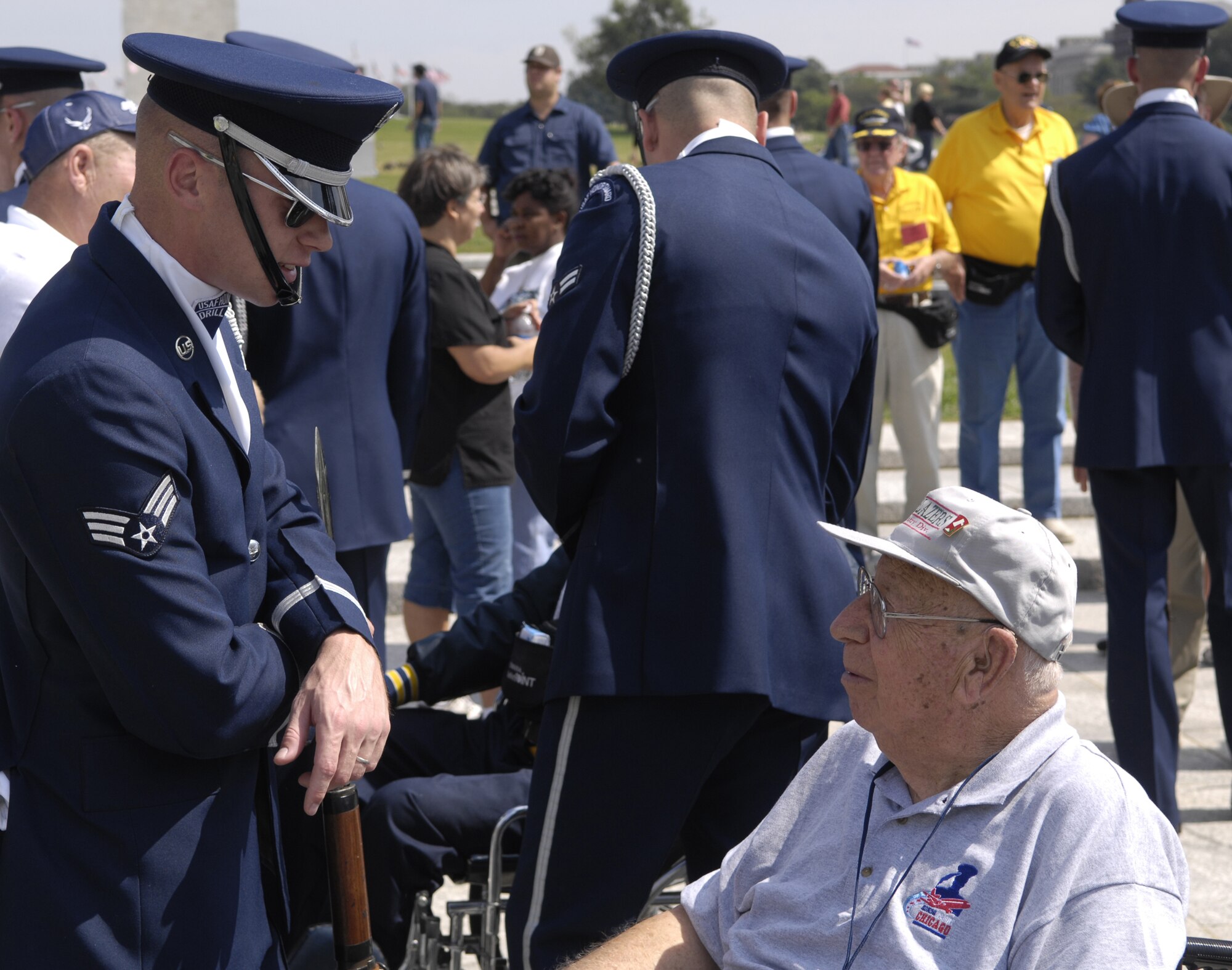 Senior Airman Brandon Bridges, U.S. Air Force Honor Guard Drill Team, talks with a World War II veteran from the Veterans of Foreign Wars Iowa Honor Flight after a performance Sept. 17 at the World War II Memorial in Washington. The show was a tribute to World War II veterans in attendance and to honor those that lost their lives during World War II. (U.S. Air Force photo by Airman 1st Class Sean Adams)