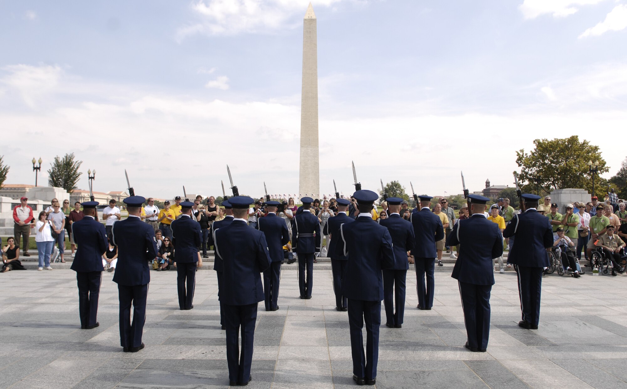 Members of the U.S. Air Force Honor Guard Drill Team stand ready to perform for a crowd Sept. 17 at the World War II Memorial in Washington. The show was a tribute to World War II veterans in attendance and to honor those that lost their lives during World War II. (U.S. Air Force photo by Airman 1st Class Sean Adams)