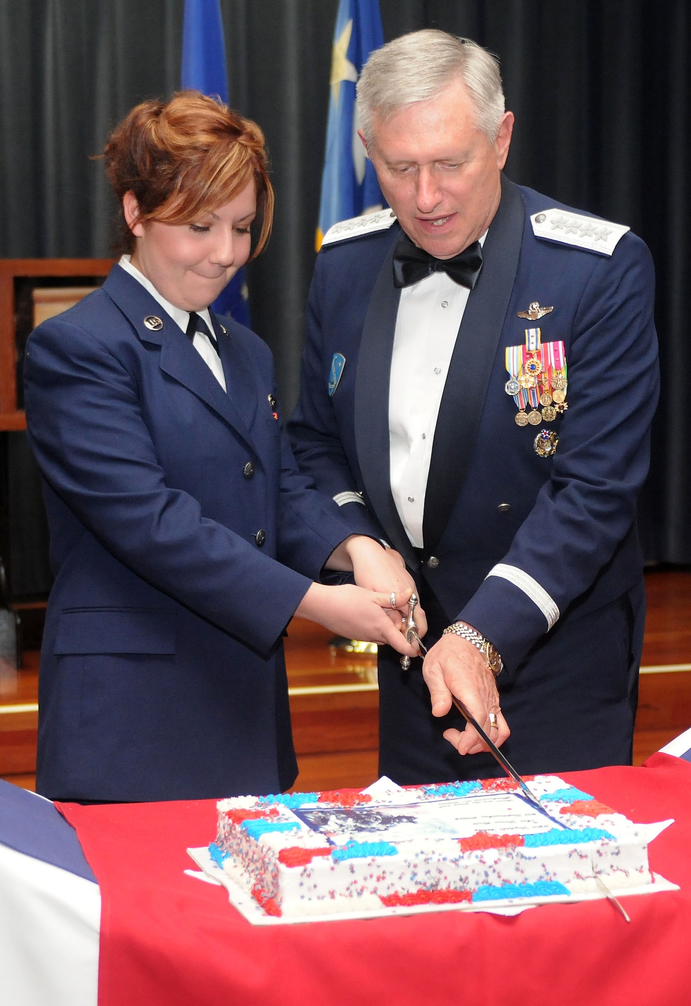 Airman Basic Mallory L. Gipson, 52nd Maintenance Operations Squadron, and Gen. Roger A. Brady, U.S. Air Forces in Europe commander, cut the cake during the Air Force Ball held on Spangdahlem Air Base, Germany, Sept. 20, 2008. Traditionally, the cake is cut by both the highest and lowest ranking member in attendance. The 2008 Air Force Ball commemorates the Air Force’s 61st birthday. (U.S. Air Force photo by Master Sgt. Alexander Ray)