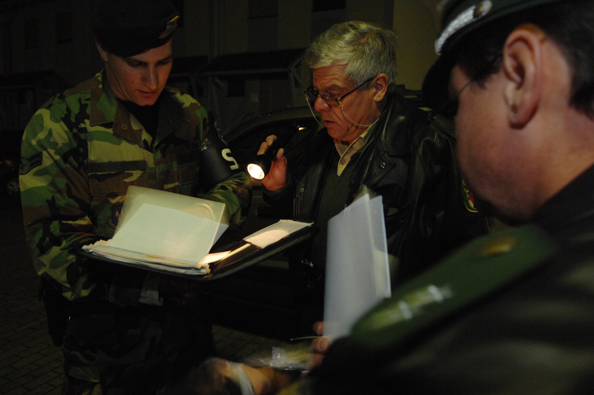 United States Air Force Airman 1st Class William Wray (left), 569th United States Forces Police Squadron, Polizei officers Karl Mayer and Udo Kranz look for items with sensitive information found in an unsecure vehicle, Landstuhl, Germany, Sept. 18, 2008. (U.S. Air Force photo by Senior Airman Amber Bressler)(RELEASED)
