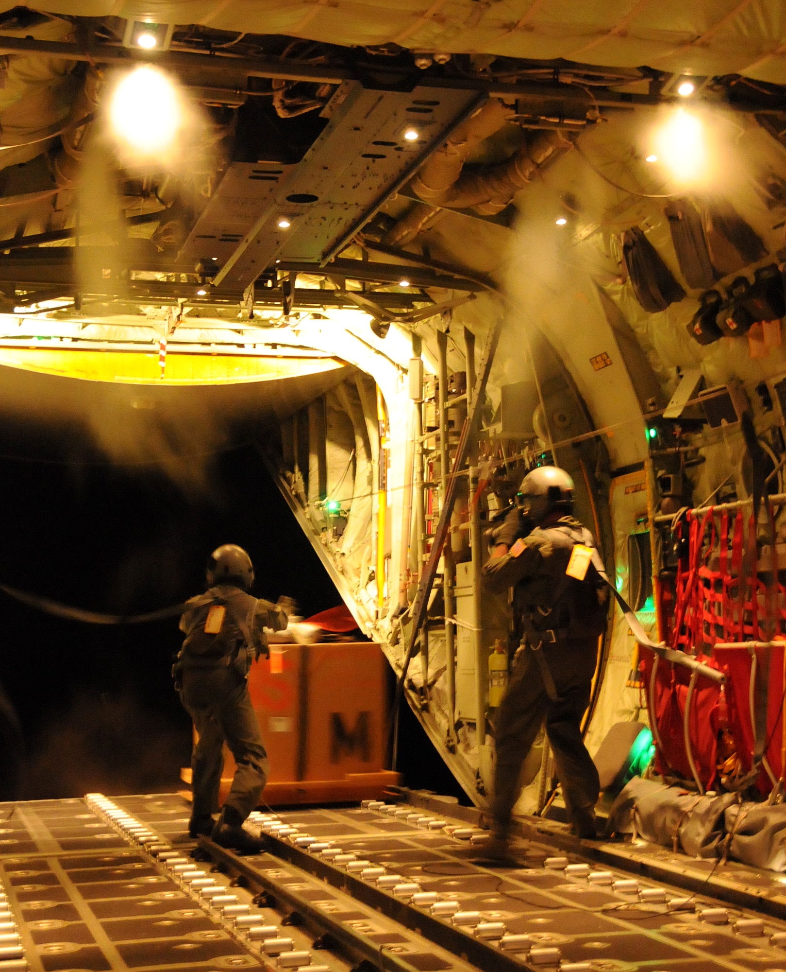 ANDERSEN AIR FORCE BASE, Guam - Master Sgt. Jeff Stack and Tech. Sgt. Vincent Burden, 53rd Weather Reconnaissance Squadron weather loadmasters, release one of 12 $40,000 oceanic data buoys from the cargo bay of a WC-130J Sept. 20.  The "Hurricane Hunters" deployed the buoys to measure the ocean's interaction with the atmosphere as Typhoon Hagupit passes the buoy. The Air Force Reserve Command?s ?Hurricane Hunters,? deployed to Andersen from Keesler AFB, Miss., to conduct meteorological research on tropical cyclones in the Western Pacific.  (U.S. Air Force photo by Airman 1st Class Courtney Witt)
