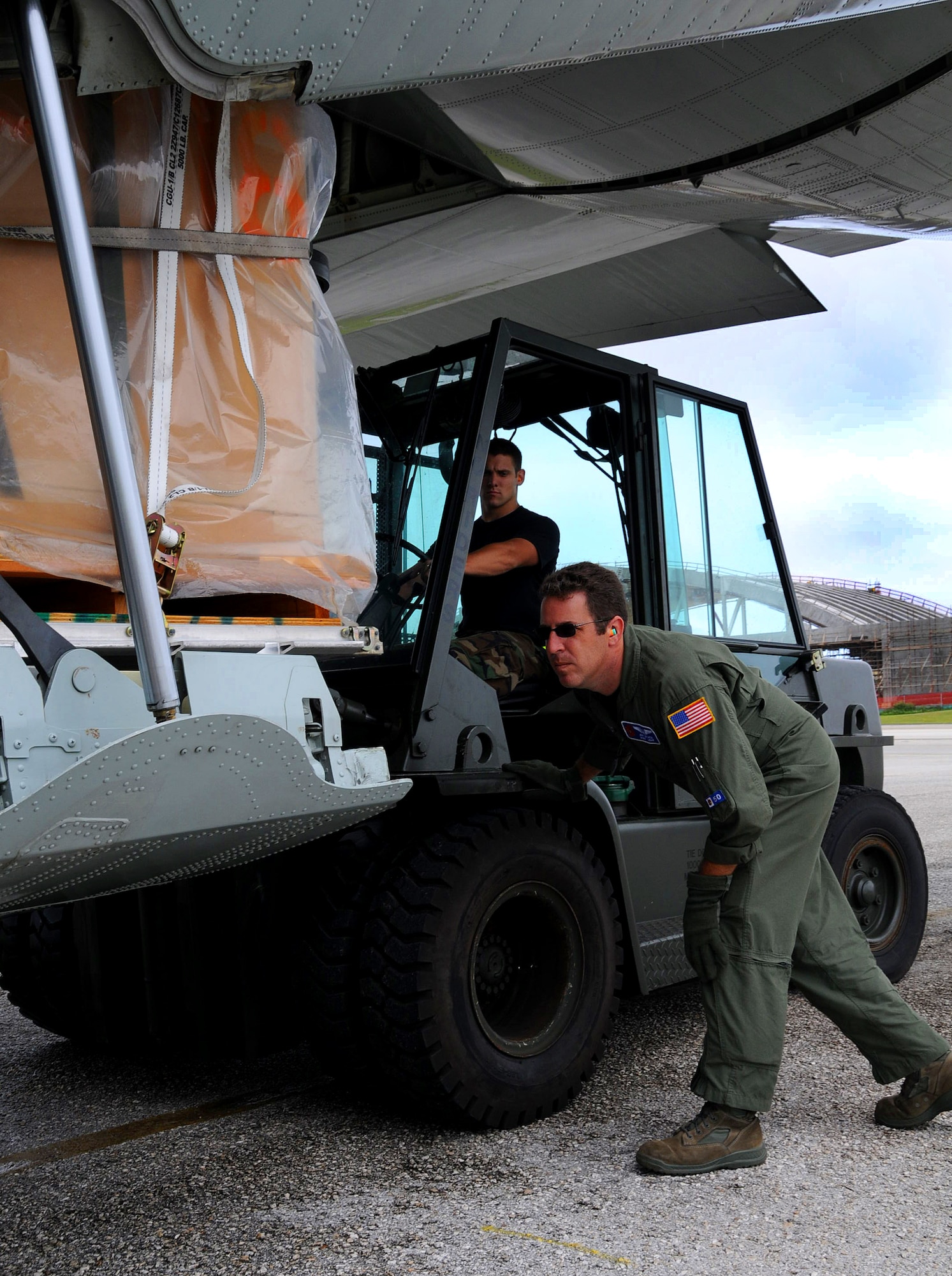 ANDERSEN AIR FORCE BASE, Guam - Master Sgt. Jeff Stack, 53rd Weather Reconnaissance Squadron weather loadmaster, guides Airman 1st Class Joe Olsen, 734th Air Mobility Squadron air transportation apprentice, as he loads a pallet of buoys onto an Air Force Reserve WC-130J.   The 53rd WRS uses the buoys to record the ocean?s interaction with the atmosphere.  The 53rd WRS, deployed here from Keesler AFB, Miss., to conduct meteorological research on tropical cyclones in the Western Pacific.  The study runs through the end of September. (U.S. Air Force photo by Airman 1st Class Courtney Witt)

