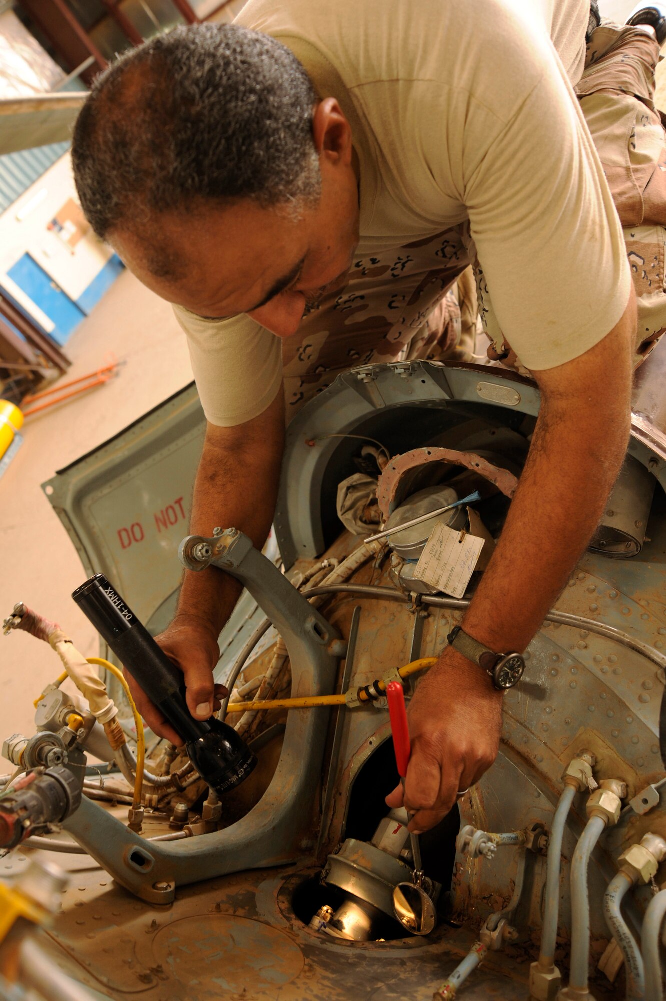 Iraqi Air Force Lt. Col. Auday Yasseu Yousif inspects a section of the tail rotor drive shaft of a Mi-17 Hip helicopter at Al Taji Air Base, Iraq, Sept. 11. The helicopter had made a hard landing and struck its tail skid against the ground, requiring a close inspection of its tail section. Yousif is chief engineer for Iraqi air force Squadron 4 second-line maintenance. (U.S. Air Force photo/Staff Sgt. Paul Villanueva II)
