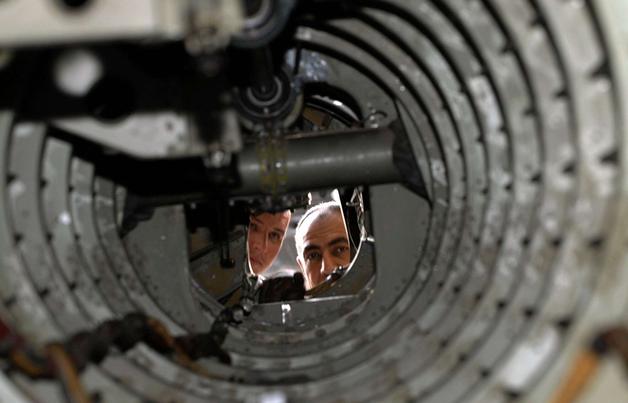 Tech. Sgt. Lee Everhart, left, and Iraqi air force Lt. Col. Auday Yasseu Yousif inspect the inside of a tail boom on a Mi-17 Hip helicopter at Taji Air Base, Iraq, Sept. 11. The Mi-17 had made a hard landing and struck its tail skid against the ground during a recent training mission, requiring close inspection of its tail section. Yousif is Iraqi air force Squadron 4 chief engineer. Everhart, an Mi-17 air adviser with the 770th Air Expeditionary Advisory Squadron, is deployed from Robins Air Force Base, Ga. His hometown is Lexington, N.C. (U.S. Air Force photo/Staff Sgt. Paul Villanueva II)