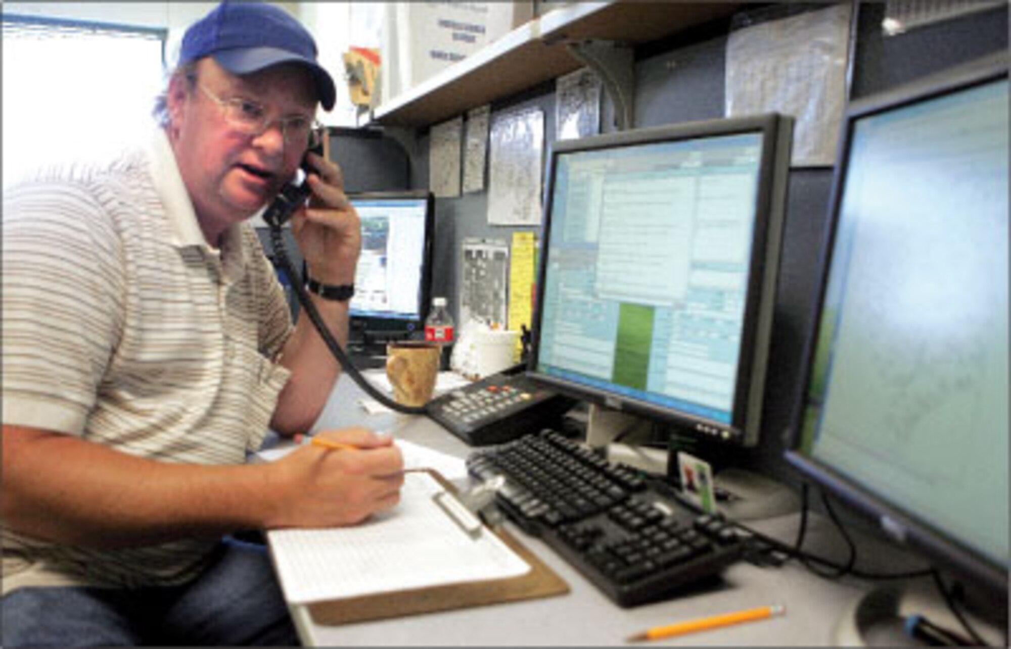 Shorty Hayward gives a flight weather briefing to a soldier while working at the Fort Hood’s weather station on Aug. 7. (Photo by Steven Doll)