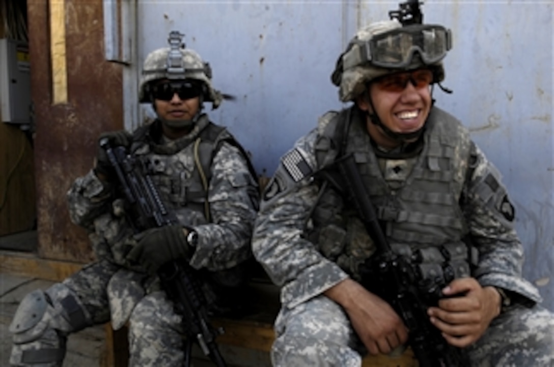 U.S. Army Spc. Gabriel Meza and Spc. Randel Smith wait to step out for a foot patrol of the surrounding areas around Joint Security Station Hurriyah 2 on July 3, 2008.  The U.S. Army soldiers are assigned to 3rd Platoon, Bravo Company, 1st Battalion, 502nd Infantry Regiment, 101st Infantry Division.  