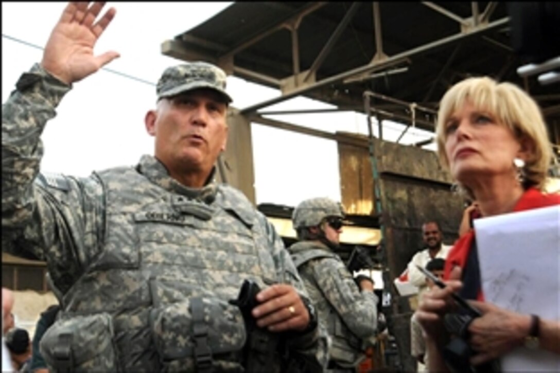 U.S. Army Gen. Raymond T. Odierno, commander, Multinational Force Iraq, answers questions posed by 60 Minutes reporter Lesley Stahl during his visit to the People's Market in the Sadr City district of Baghdad, Iraq, Sept. 18, 2008. 
