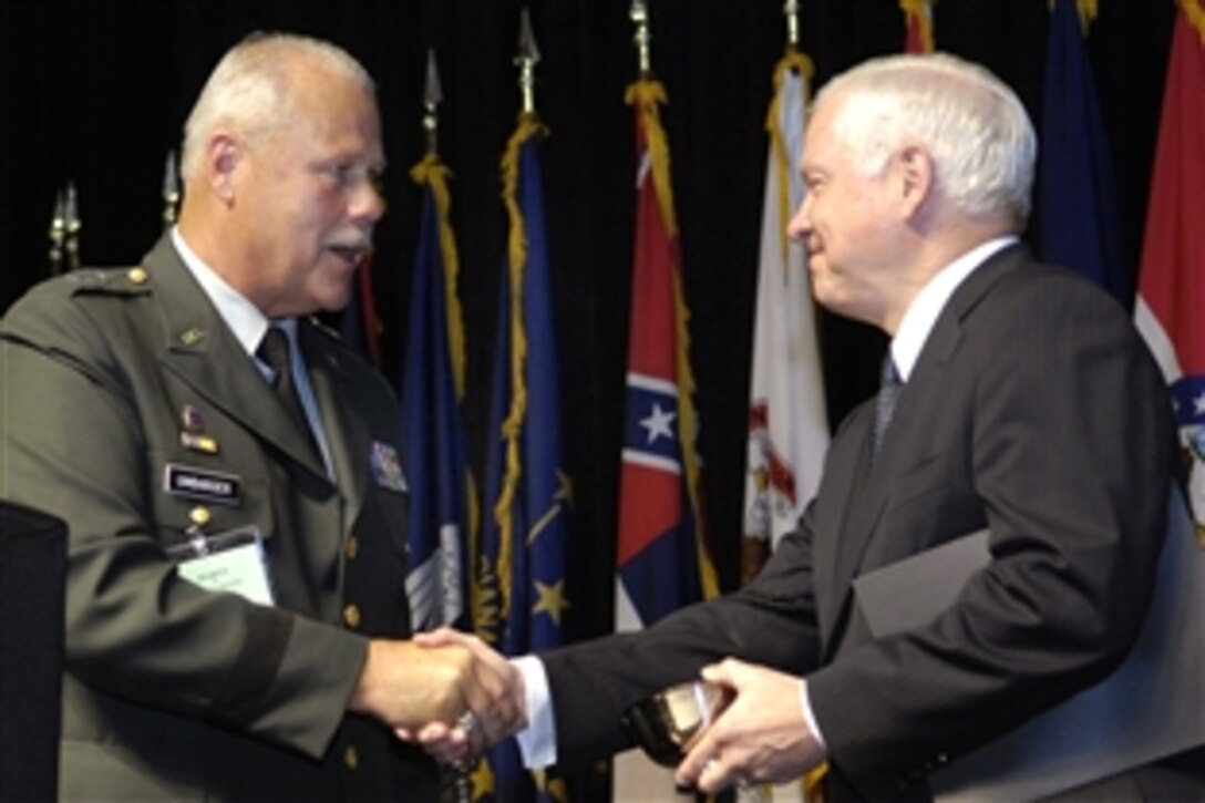 Defense Secretary Robert M. Gates, right, receives a gift from Army Maj. Gen. R. Martin Umbarger, chairman of the National Guard Association of the United States, during the 130th National Guard Association of the United States Convention in Baltimore, Md., Sept. 22, 2008. The audience included about 2,500 guardsmen and thier families, senior military leaders, defense industry representatives, and local, state and federal elected officials.  