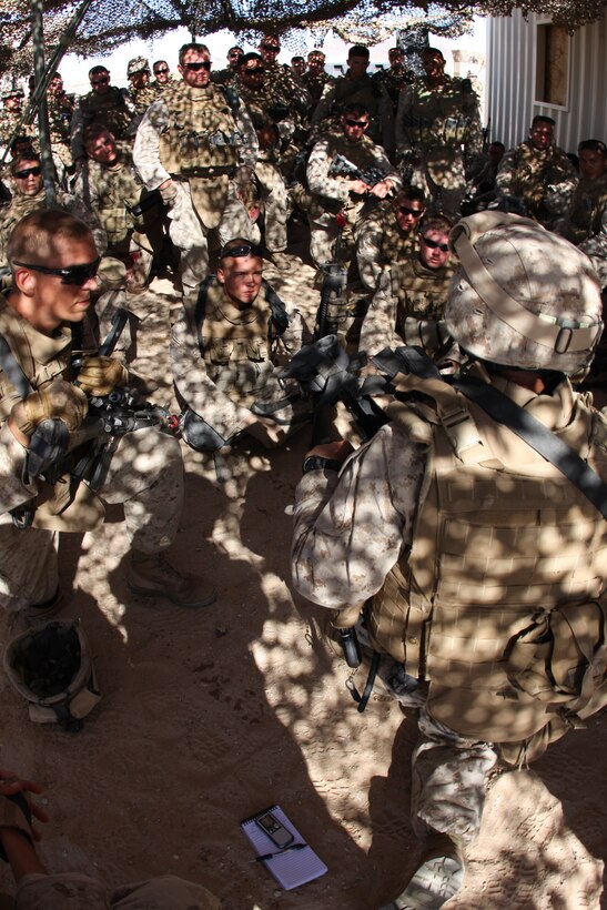 Marines with 2nd Platoon, Company L, 3rd Battalion, 8th Marine Regiment, discuss their mission and objectives at Afghan National Police office in Sara Kowt, a mock Afghan town aboard the Combat Center’s training area, before heading out on a patrol of surrounding villages during a three-day-long final exercise Sept. 23 for a new Afghanistan-specific pre-deployment training evolution, known as Mojave Viper.