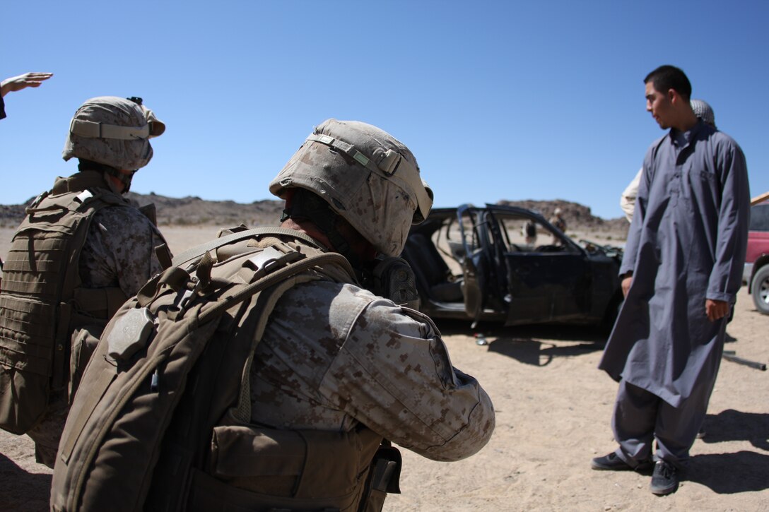 Marines with 2nd Platoon, Company L, 3rd Battalion, 8th Marine Regiment, search Kala, a mock Afghan town aboard the Combat Center’s training area, while on patrol of the town and interacting with the role-playing local populace during a three-day-long final exercise Sept. 23 for a new Afghanistan-specific pre-deployment training evolution, known as Mojave Viper.
