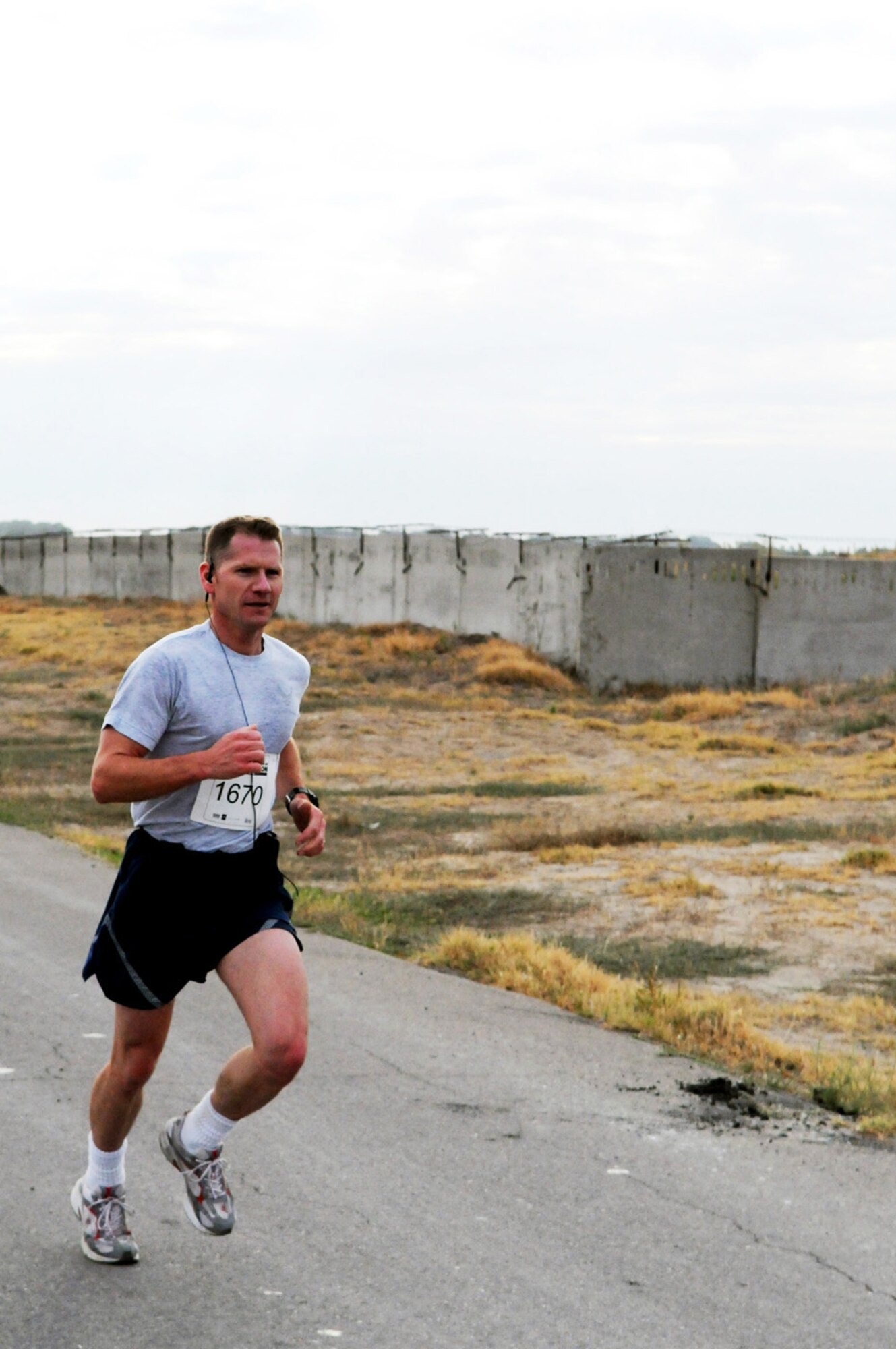 Maj. Damien Pickart pushes through mile 12 of the 26.2 mile Manas Air Base version of the Air Force Marathon. More than 40 deployed servicemembers here particapated in the event. (Air Force photo / Senior Airmen Ruth Holcomb)