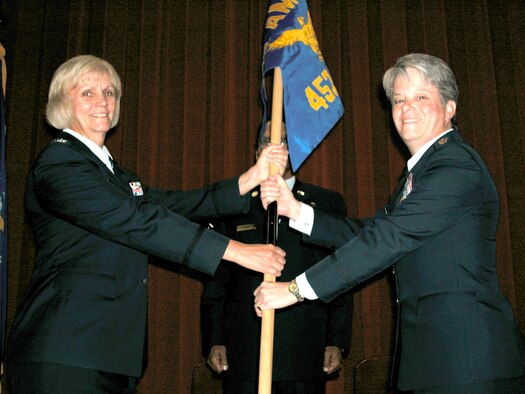 Col. Pam LeBlanc, 452 Mission Support Group commander, left, hands the 452nd Mission Support Squadron flag to Major Maureen H. McAllen, the new commander, during a Change of Command ceremony, Sunday. Maj. McAllen replaces outgoing commander Lt. Col. Lisa Yacoub, who is now executive officer at Fourth Air Force. Maj. McAllen, who began her career as an enlisted reservist in 1986, most recently served as executive officer at Fourth Air Force. During her career, Maj. McAllen has been mobilized for Operation Enduring Freedom and deployed to Baghdad for  Operation Iraqi Freedom. (U. S. Air Force photo by Master Sgt. Michael Blair)
