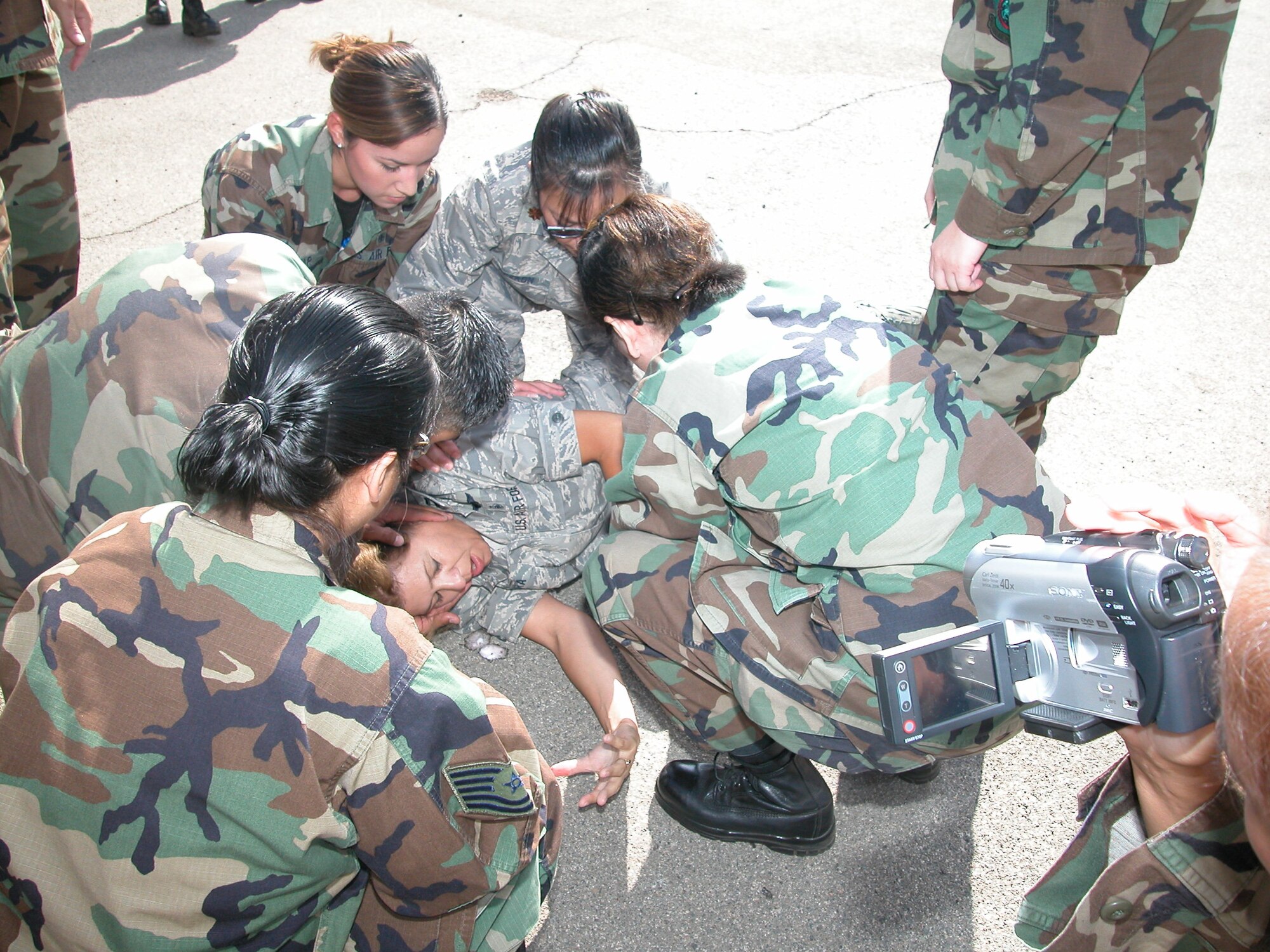 “Seizure patient” Capt. Diane Caldera, 452 AMDS, receives aid from a 452 AMDS medical team during the mass casualty drill. Helping are: Maj. Griselda Tiu, Maj. Doris Aceron, Staff Sgt. Vanessa Tovar, Capt. Marcos Sandoval-Garcia, and Tech. Sgt. Jeannette Patacsilhardin. (U.S. Air Force photo  by Staff Sgt. Joe Davidson)