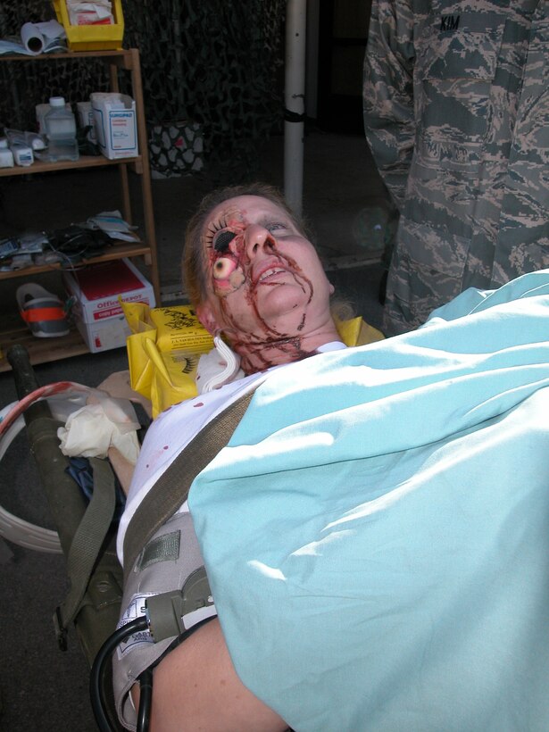 Master Sgt. Leeanne Bowden, administrator, 452 AMDS, acted as a casualty who may not have had the worst injury, but it was certainly not pleasant to look at. (U.S. Air Force photo  by Staff Sgt. Joe Davidson)