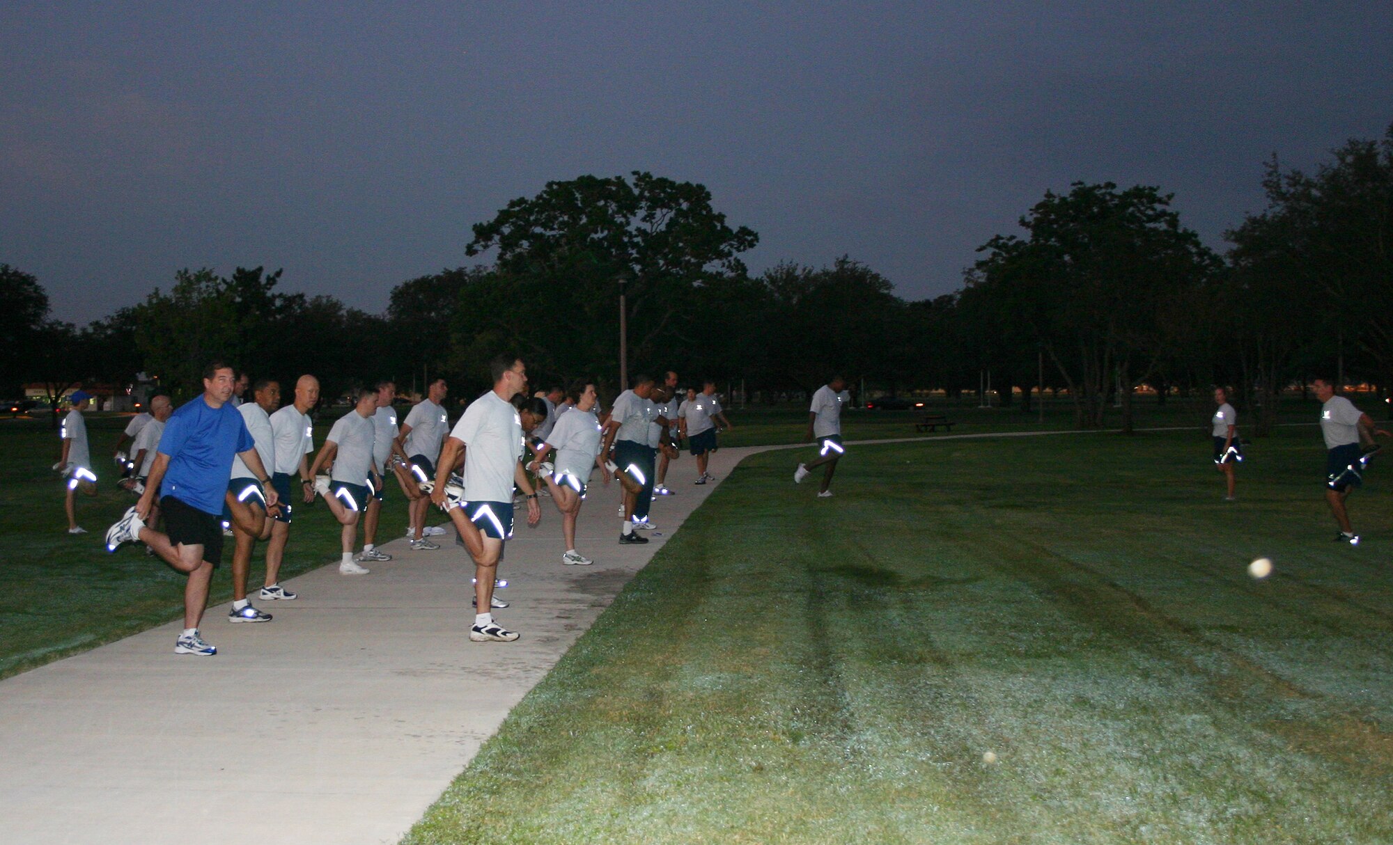 Airmen at the Air Force Personnel Center, Randolph Air Force Base, Texas, stretch before an AFPC unit run Sept. 23 at the Airmen's Heritage Park. This 1.8 mile event was the first of four monthly unit runs AFPC Airmen will hold to prepare for a formation run in January 2009. (U.S. Air Force photo/Maj. Beth Horine) 