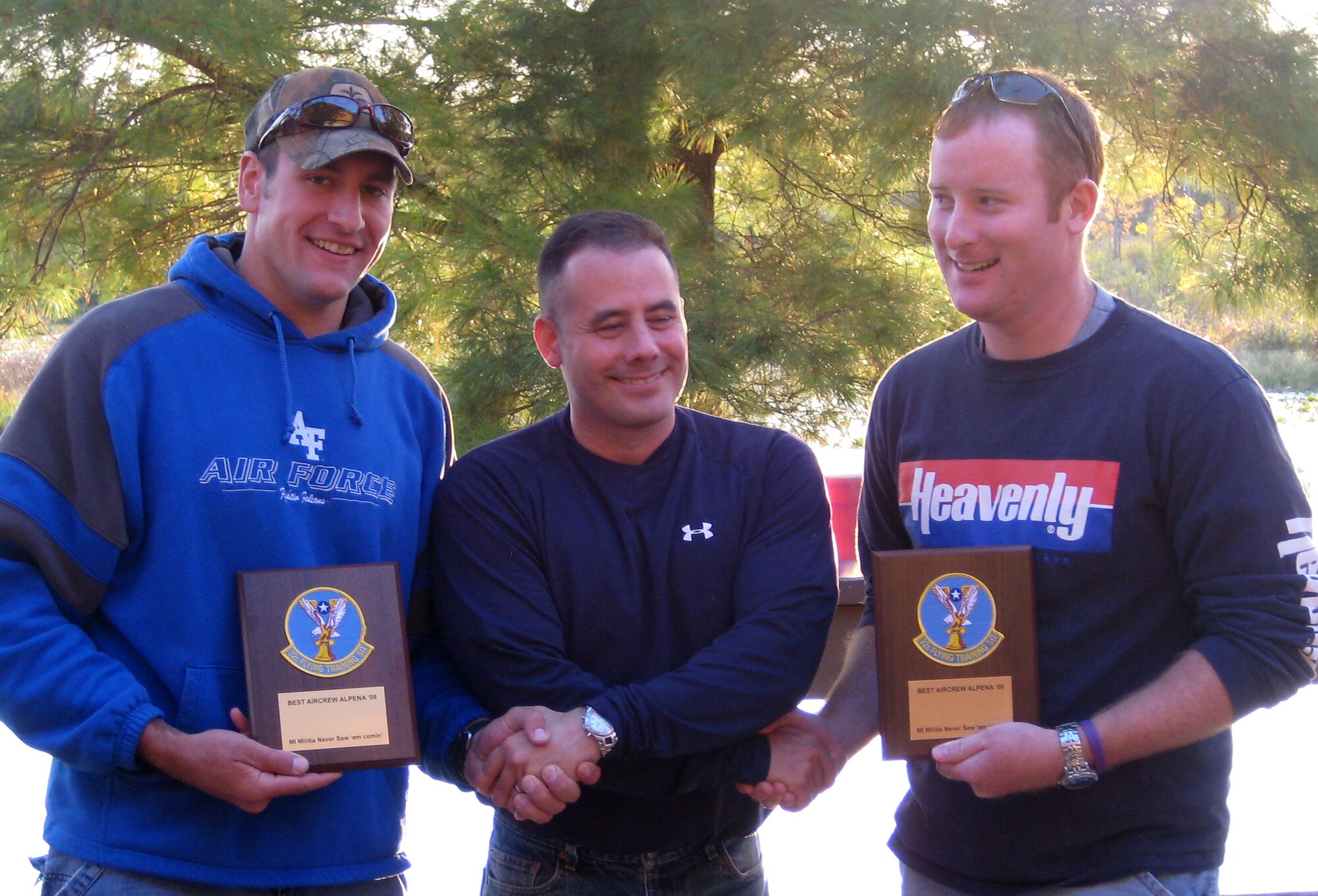 Lt. Col. Dave Morrissey, the 32nd Flying Training Squadron commander, center, congratulates Capt. Sam McCurry, left, and Capt. Kevin Seay, on winning the “rodeo” flying competition during the 32nd FTS’s deployment to the Combat Readiness Training Center in Alpena, Mich. (U.S. Air Force photo)