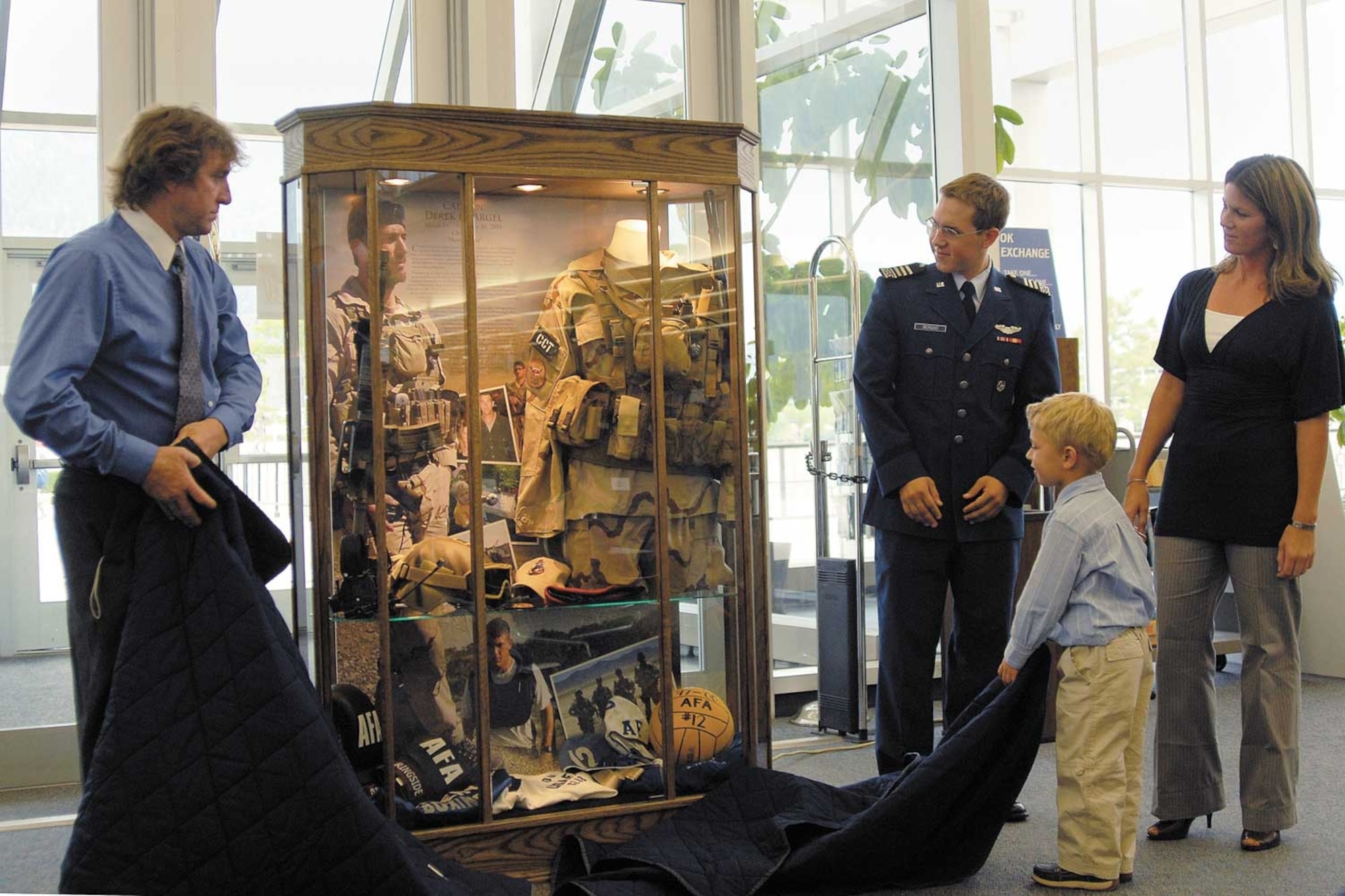 Photo by Rachel Boettcher
The memorial display case for Captain Derek Argel is unveiled. The case will be permanently displayed in Cadet Squadron 2, the squadron Captain Argel was assigned to as a cadet. Capt. Jeremy Fresques’ display will be in CS-29.
