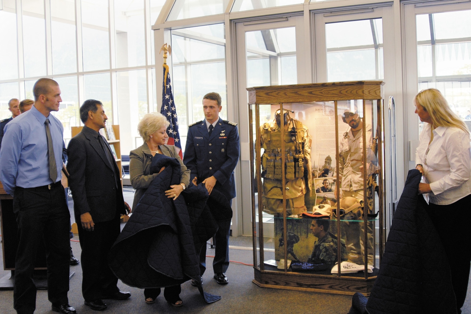 Friends and family unveil the memorial display case for Capt. Jeremy Fresques at the McDermott Library Sept. 5. Photo by Rachel Boettcher