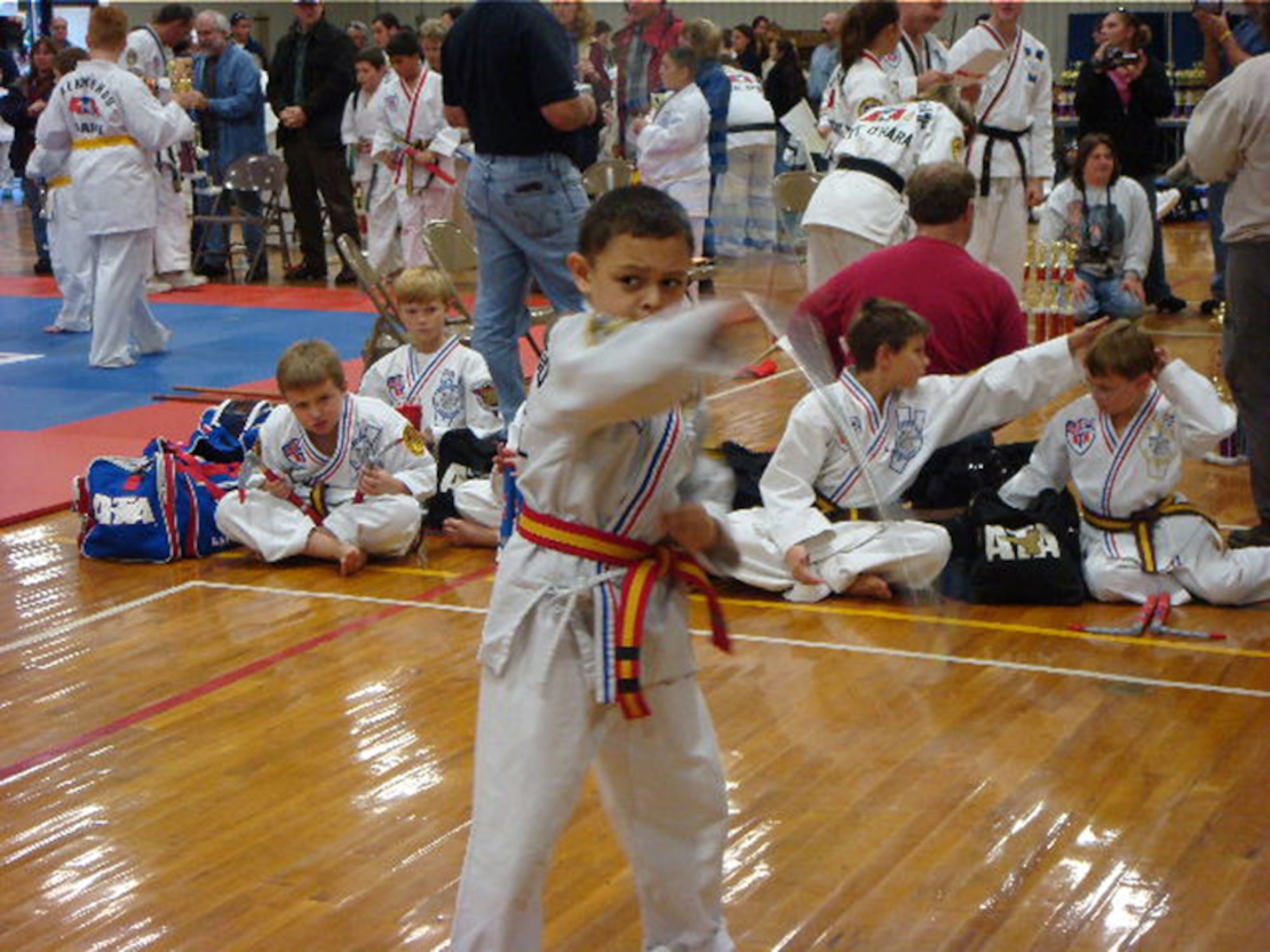 Austin Bell, 8, demonstrates his tae kwon do skills while wielding a bo staff during a competition. Austin and his father, Army Sgt. 1st Class Tim Bell, an Army Reserve Career counselor, were both named state champions in American Tae Kwon Do Association competitions for the second year in a row. After competing in several competitions over the course of the year, Sergeant Bell came in first place in the traditional weapons, Xtreme forms and Xtreme weapons categories in the 40- to 49-year-old age bracket, while his son placed first in the same categories in the children's bracket. In 2007, both father and son were named state champions in the traditional weapons category. Both father and son live on Hanscom AFB. (Courtesy photo)