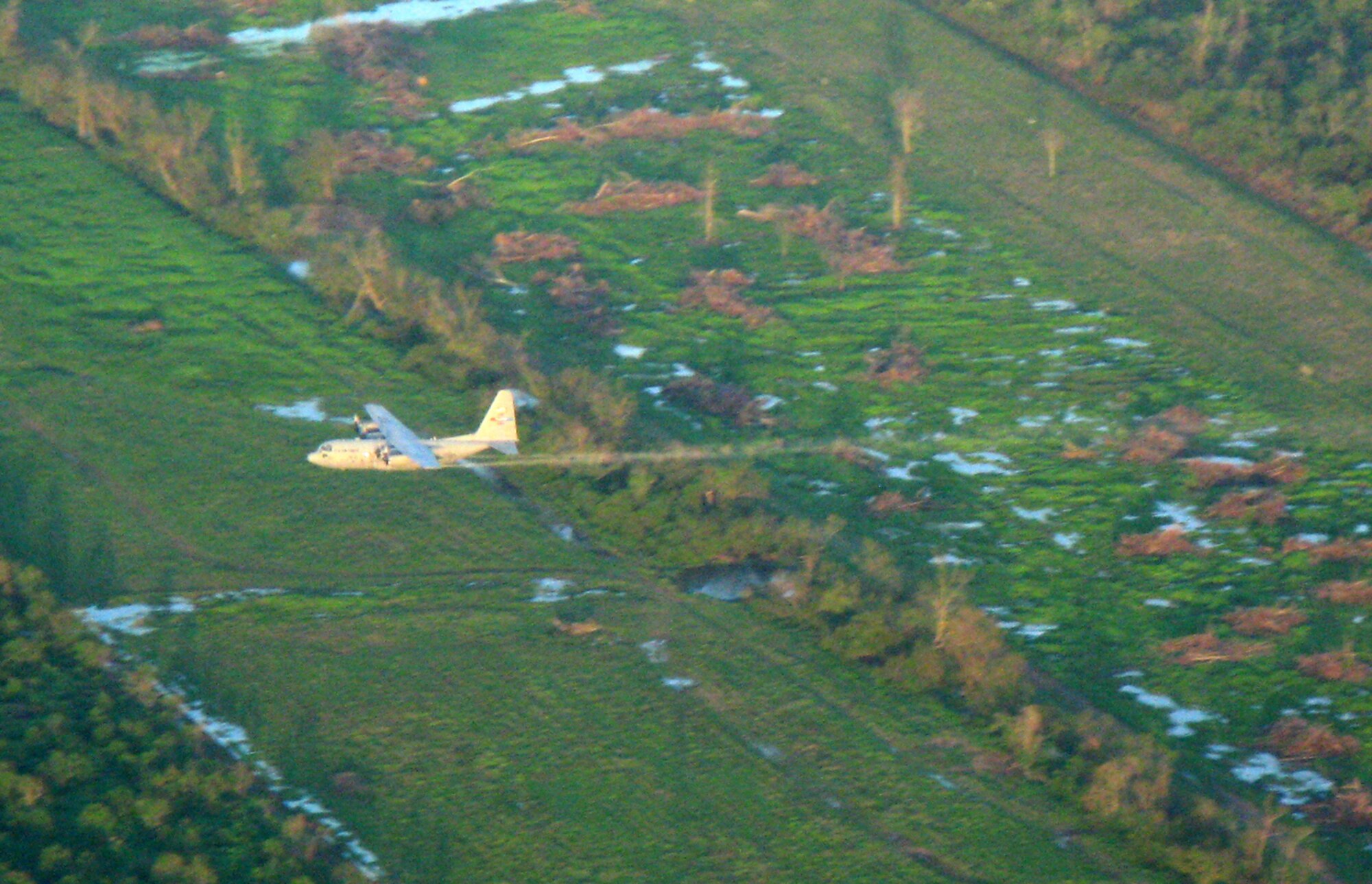 BATON ROUGE, La—- An Air Force Reserve C-130 assigned to the 910th Airlift Wing Youngstown, Ohio aerial spray LaFourche Parish September 21 in Southern Louisiana as part of disaster relief efforts to help area residents.  C-130s are required to fly at only 150 feet above ground to effectively eradicate mosquito infestations eliminating the potential for the spread of West Nile Virus and Encephalitis.  Aerial spraying will continue for the next week ultimately spraying nearly 900,000acres. Photo by Calvin Telleson (FEMA Broadcast Operations)