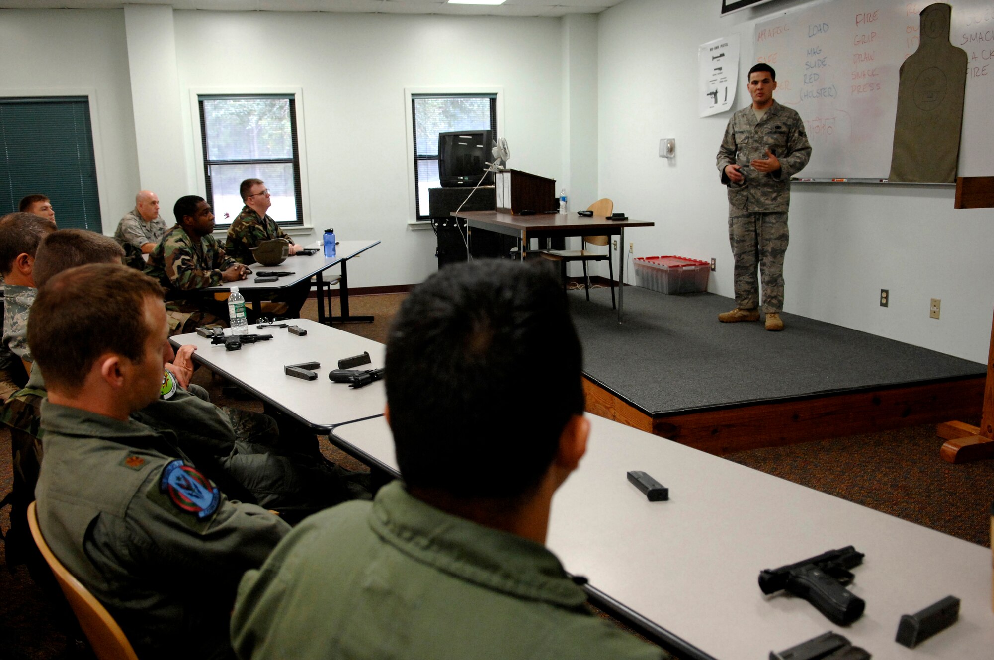HURLBURT FIELD, Fla. -- Senior Airman Nicolo Solarino, a 1st Special Operations Security Forces Squadron combat armsman, teaches a class of Airmen the proper use of a 9 mm handgun here, Sept. 18. The class teaches each student the fundamentals for safe use and proficiency. It?s mandatory for all Air Force personnel to be qualified on their primary and supplemental weapons prior to deployment.  (U.S. Air Force photo/ Senior Airman Julianne Showalter)