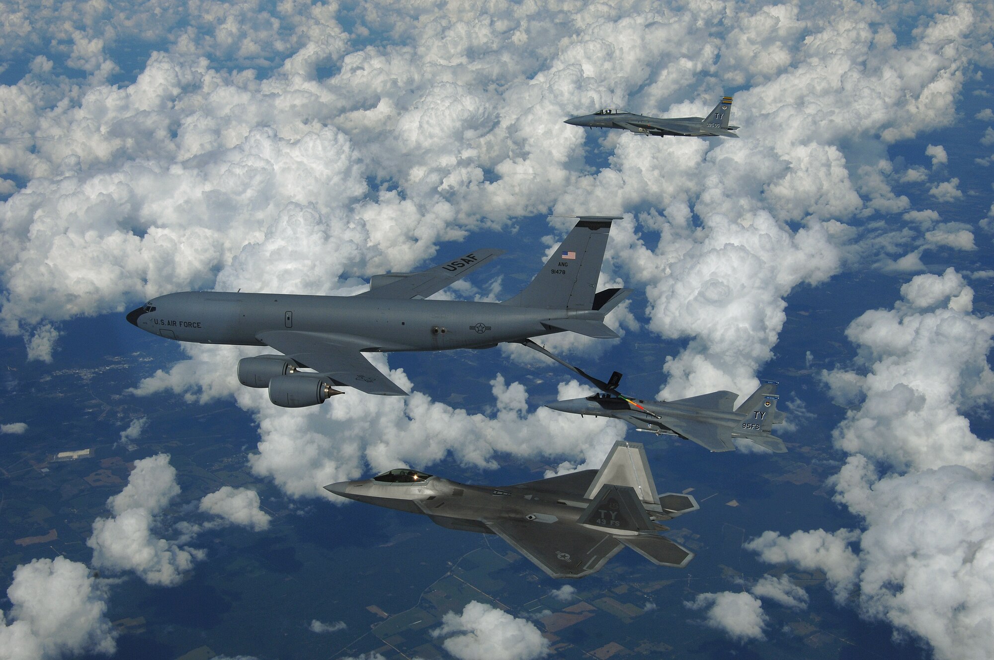 An F-22 Raptor and two F-15 Strike Eagles from Tyndall Air Force Base, Fla participate in a refueling mission with a KC-135 from the Mississippi Air National Guart over eastern Florida, September 22, 2008. (US Air Force photo by Master Sgt. Scott Reed)