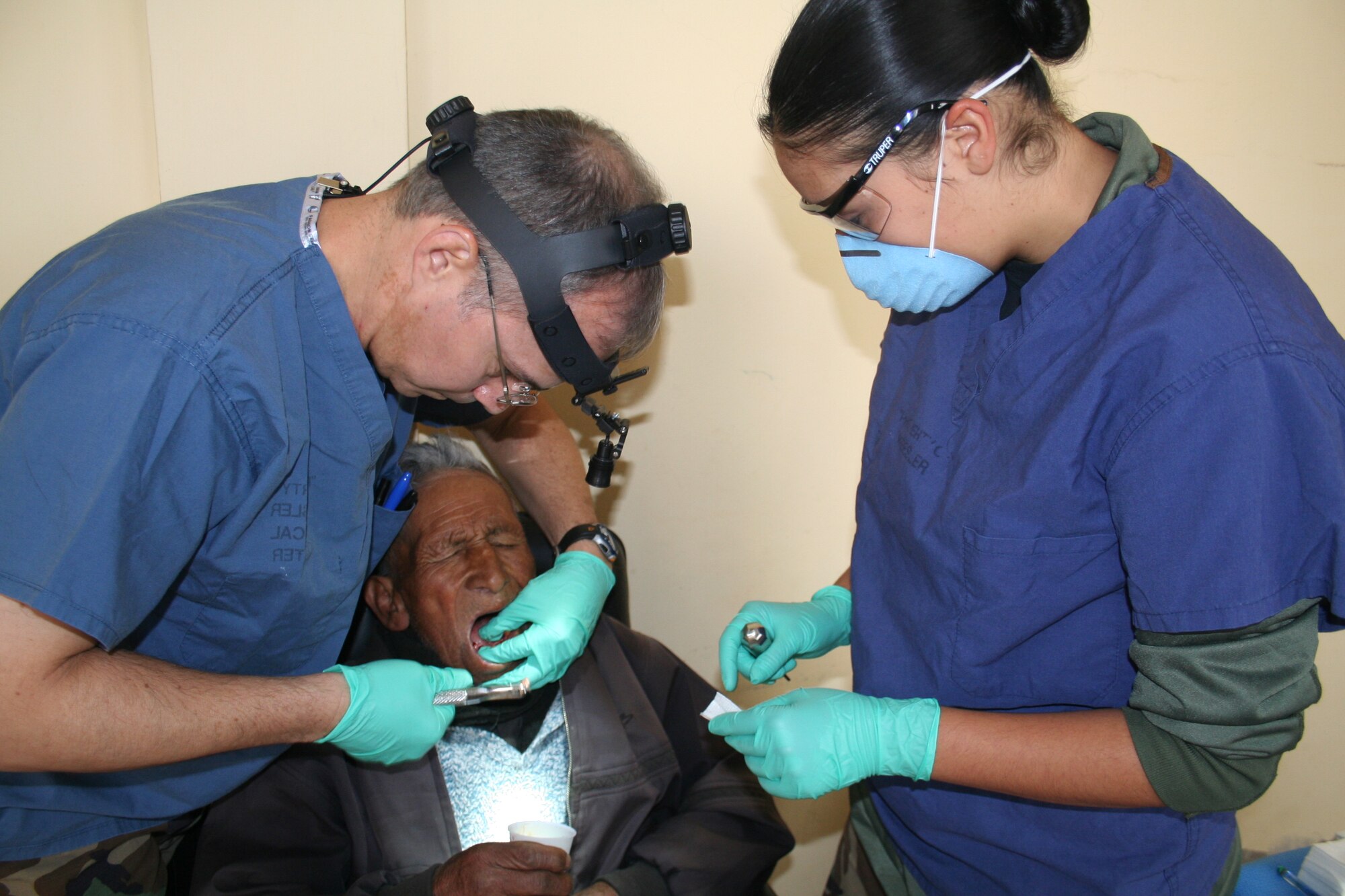 Dentist Col. (Dr.) Joseph Novak, left, 81st Dental Squadron, prepares to extract a tooth with the assistance of dental technician Airman 1st Class Veronica Reesey.  Both are members of the 81st Dental Squadron.