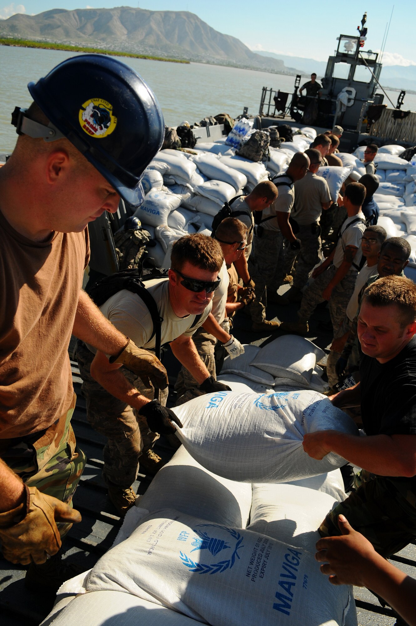 GONAIVES, Haiti -- Airmen from Minot Air Force Base’s 5th Civil Engineer Squadron Prime Base Engineer Emergency Force and Navy Seabees abord the USS Kearsarge ??(LHD 3) unload supplies to aid those affected by the recent tropical storm and hurricanes in Haiti. Approximately 40 Airmen from 5th CES are supporting Continuing Promise 2008, a four-month mission in the U.S. Southern Command area of responsibility. (U.S. Navy photo by Mass Communication Specialist ?Seaman Apprentice Joshua Adam Nuzzo)