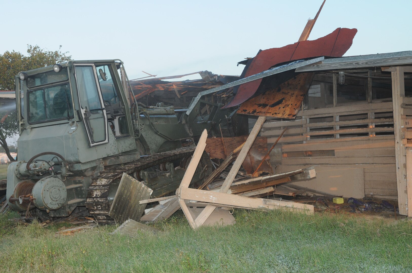 John Hernandez, 12th Civil Engineer Division, demolishes the remainder of the Randolph Air Force Base horse stables Sept. 22. A new recycling facility was recently completed on part of the land and officials plan to begin work soon on a new family camping area. (U.S. Air Force photo by Rich McFadden)