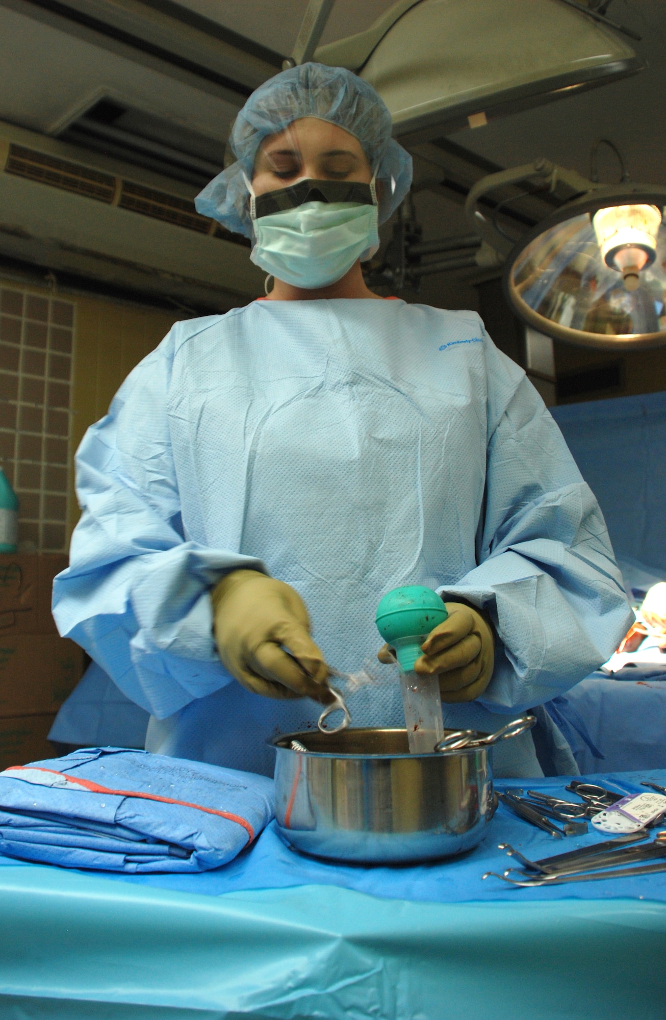 Spc. Angelique Burnham, an operating room technician from Brooke Army Medical Center in San Antonio, Texas, cleans medical instruments used during a hand and arm surgery Sept. 17 at Hospital Escuela in Tegucigalpa, Honduras. The medical team from Brooke Army Medical Center; Walter Reed Medical Center, Washington, D.C.; and Ft. Riley, Kan., screened more than 80 patients, with half of those were scheduled for surgery during the two-week period. (U.S. Air Force photo by Tech. Sgt. John Asselin)
