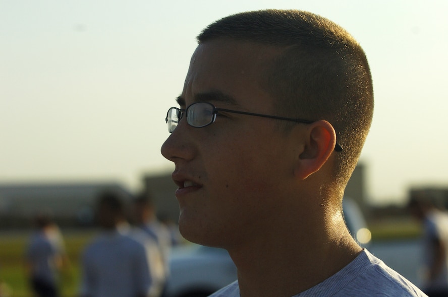 MINOT AIR FORCE BASE, N.D. – Airman 1st Class Matthew Beers, 5th Civil Engineer Squadron structural apprentice, looks on as the last of his group finish the 1.5 mile Taxiway Echo Fitness Run here Sept. 19. Airman Beers had the fastest run-time of the day finishing in 8 minutes, 5 seconds. (U.S. Air Force photo by Senior Airman Cassandra Jones)
