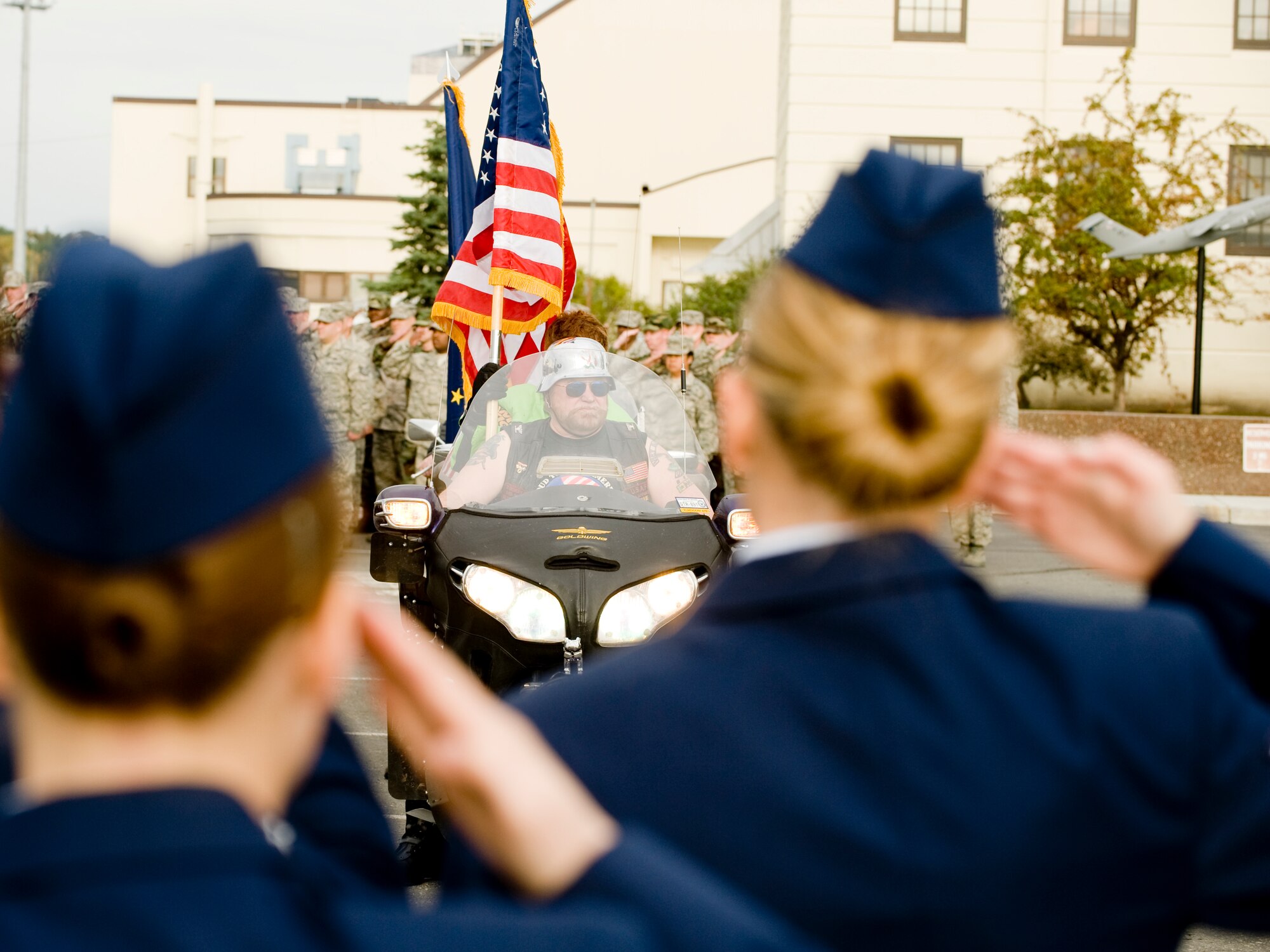 ELMENDORF AIR FORCE BASE, Alaska -- 3rd Wing Airmen render a salute as members of the Green Knights and the Vietnam Veterans Motorcycle Club arrive with the official colors for the POW/MIA Ceremony held at Heritage Park Sept. 19. The ceremony, which consisted of all military branches and the motorcycle clubs, honored all the fallen servicemembers as well as those who are under POW/MIA status. (U.S. Air Force photo/Staff Sgt. Joshua Garcia)