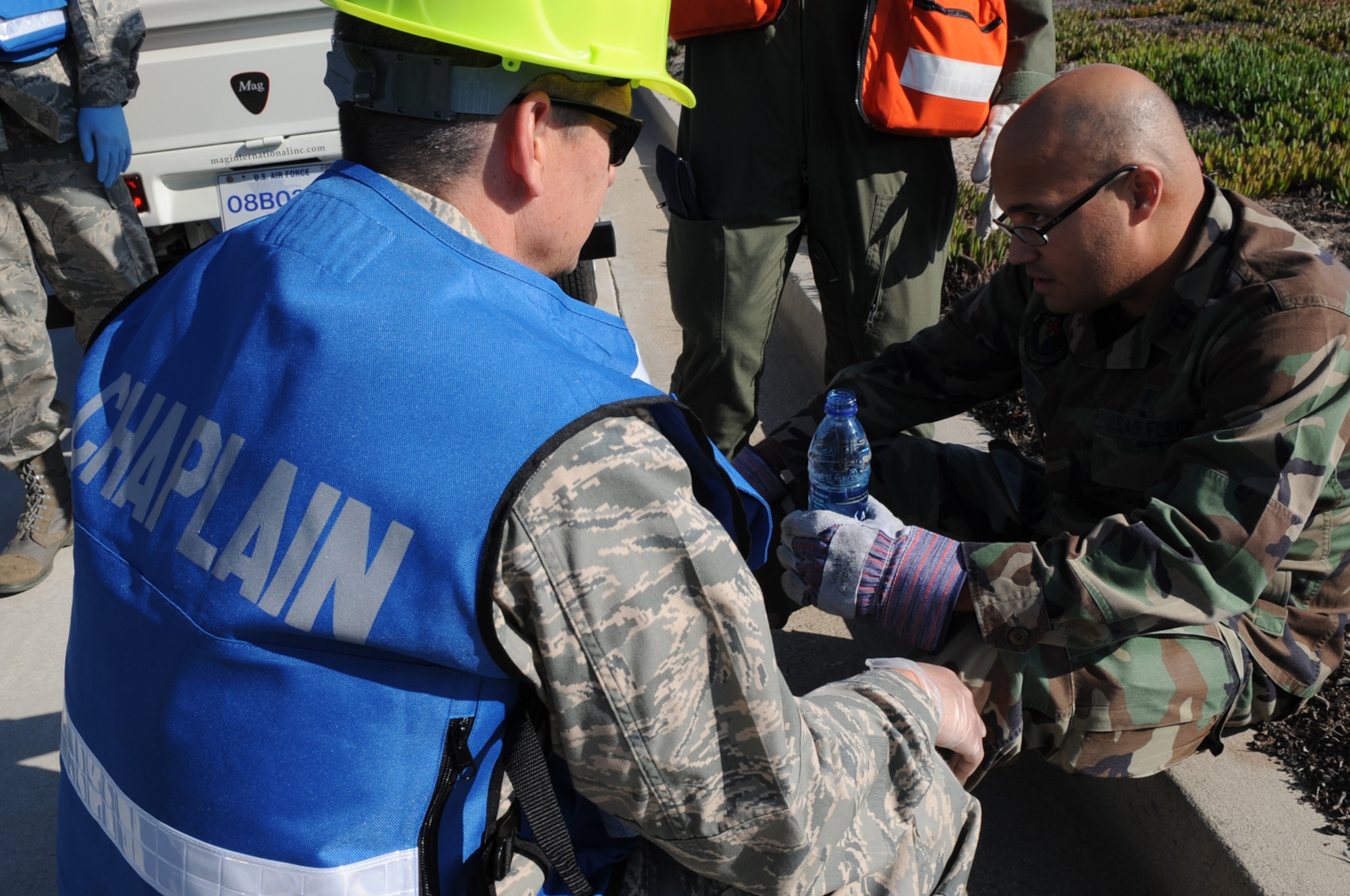 VANDENBERG AIR FORCE BASE, Calif-- Chaplain (Capt.) Mark Thomas, 30th Space Wing, gives support for Capt. Fabian Chaparro, 30th Medical Support Squadron, who simulated having stress during the search for remains after a simulated C-17 crash Sept. 17 here.  The crash was a part of the Operational Readiness Inspection.  (U.S. Air Force photo/Airman 1st Class Andrew Satran)