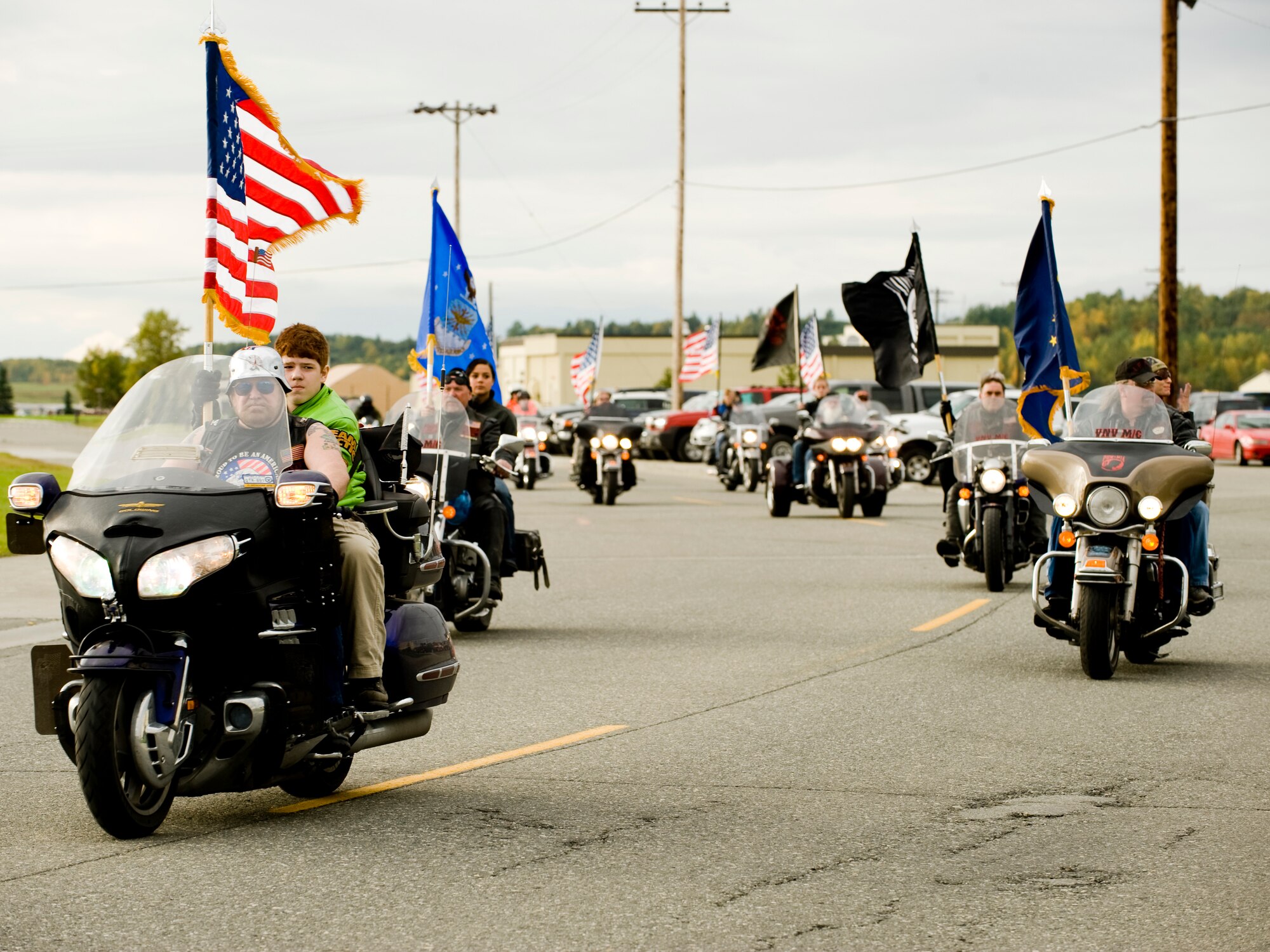 ELMENDORF AIR FORCE BASE, Alaska -- Members of the Green Knights and the Vietnam Veterans' Motorcycle Club, escort the American Flag, Alaskan Flag, Air Force Flag, and the POW/MIA flag to Heritage Park for the POW/MIA ceremony Sept. 19. The ceremony honored those who were and still are POW's or MIA status. (U.S. Air Force photo/Staff Sgt. Joshua Garcia)