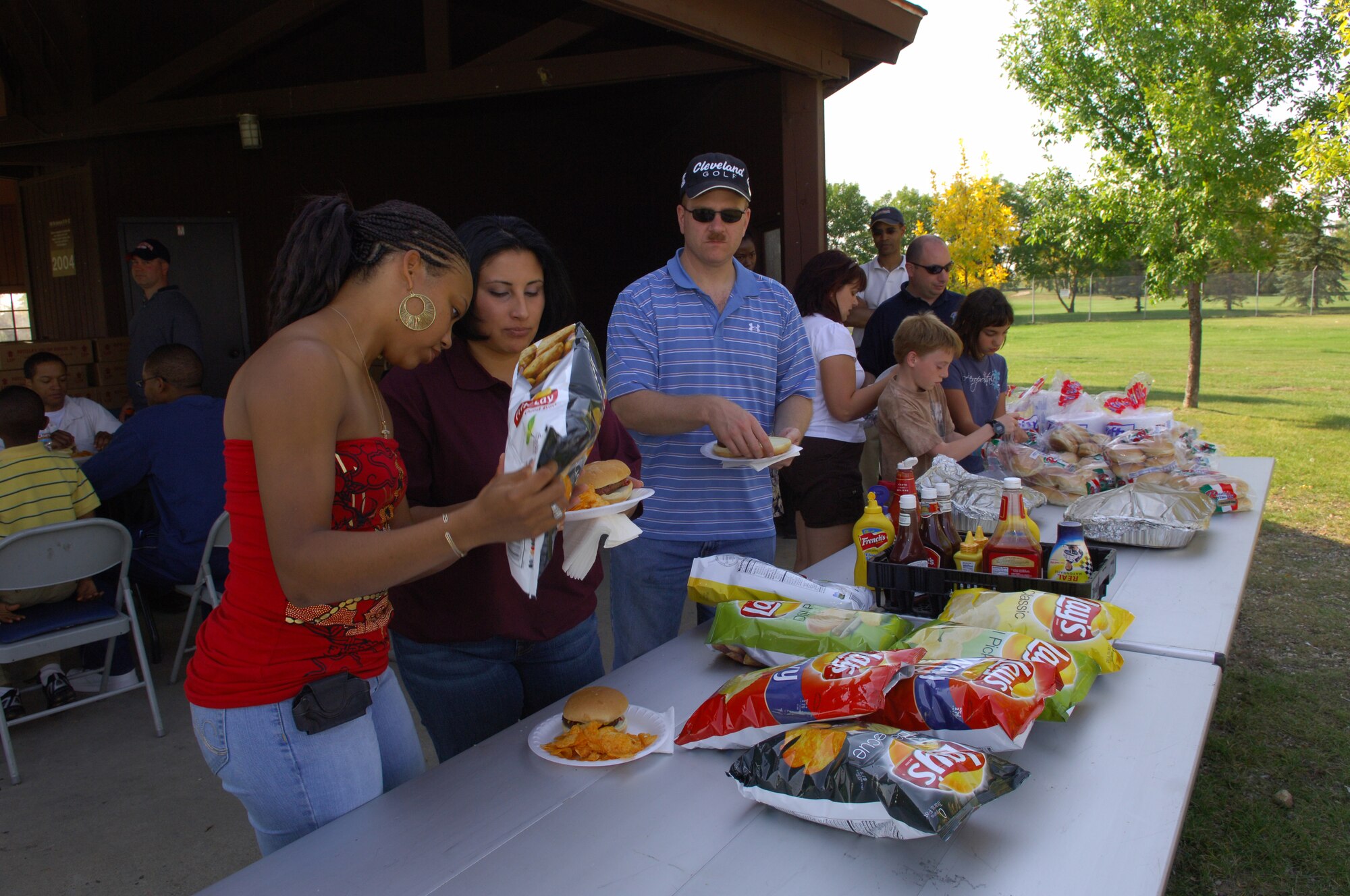 MINOT AIR FORCE BASE, N.D. – Airmen from the 91st Missile Wing and their families line up for food at a picnic at the golf course here Sept. 19. The picnic and golf tournament were designed to enhance esprit de corps and show thanks for the hard work the Airmen of the 91st MW have done in preparation for upcoming inspections. (U.S. Air Force photo by Senior Airman Cassandra Jones)