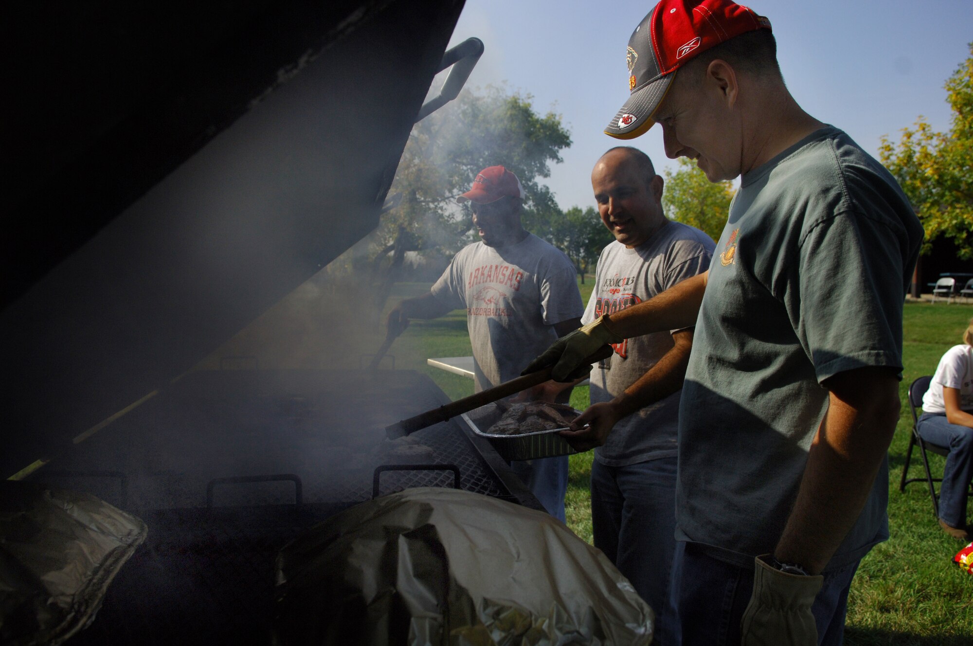 MINOT AIR FORCE BASE, N.D. –Chief Master Sgt. Brian Ballard, 91st Missile Maintenance Squadron, along with Senior Master Sgt. Juan Vadell and Master Sgt. Tylon Ellis, both from the 91st Maintenance Operations Squadron, take the burgers off the grill during the 91st Missile Wing picnic here Sept. 19. The picnic and golf tournament were designed to enhance esprit de corps and show thanks for the hard work the Airmen of the 91st MW have done in preparation for upcoming inspections. (U.S. Air Force photo by Senior Airman Cassandra Jones)