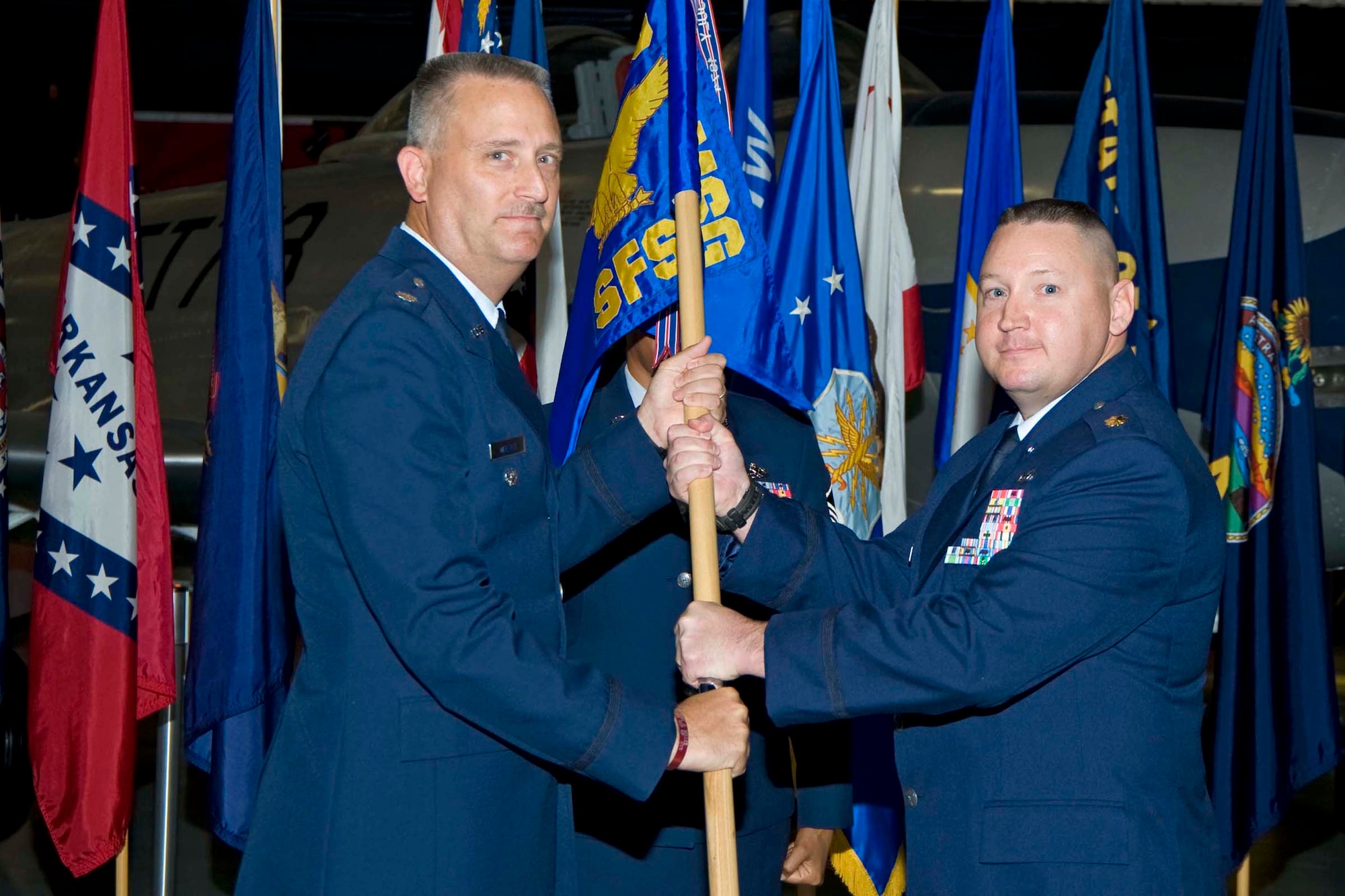 Lt. Col. Christopher Wheeler, 96th Mission Support Group commander, passes the flag to Maj. Mark Foley, 96th Security Forces Squadron commander, during the squadron's assumption of command ceremony Sept. 22. (USAF photo by Bruce Hoffman)