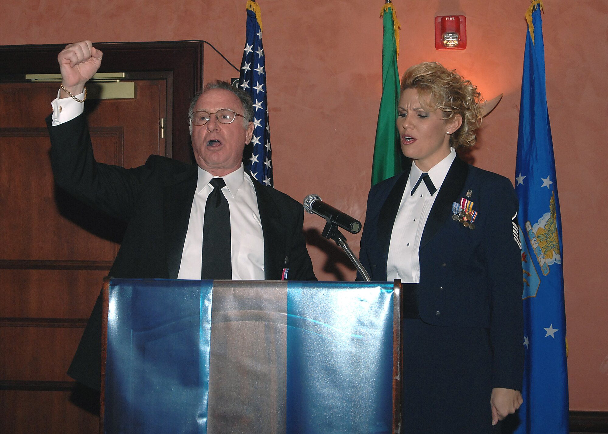 Retired Lt. Col. Mel Pollack leads fellow Airmen and civilians in singing the Air Force song with the help of Master Sgt. Angela Newby, 31st Aerospace Medicine Squadron superintendant, during the 61st Air Force Birthday Ball at the La Bella Vista Club Sept. 19. Colonel Pollack, a former Vietnam prisoner of war, was the guest speaker at this year's event. (U.S. Air Force photo/Tech. Sgt Patrick R. Hyde)
