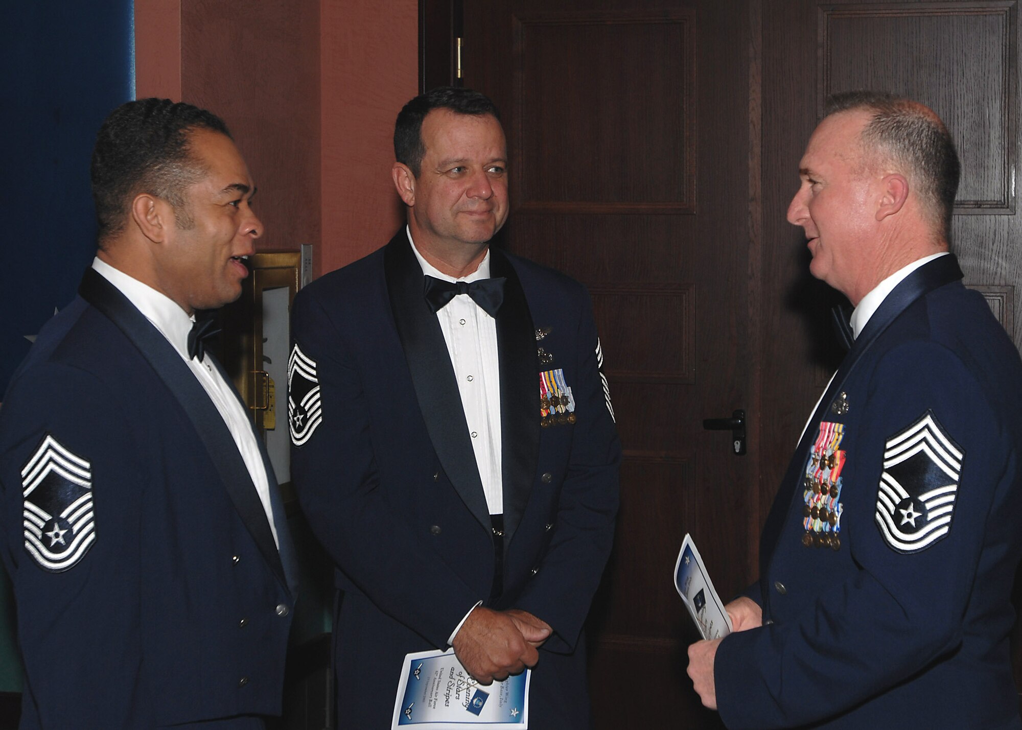 Chief Master Sgt. David Daniel, 31st Civil Engineer Squadron chief enlisted manager, Chief Master Sgt. Mike Guthrie, 31st Maintenance Group chief enlisted manager, and Chief Master Sgt. Mike Cote, 31st Communications Squadron chief enlisted manager, mingle during the 61st Air Force Birthday Ball at the La Bella Vista Club Sept. 19.  (U.S. Air Force photo/Tech. Sgt Patrick R. Hyde)