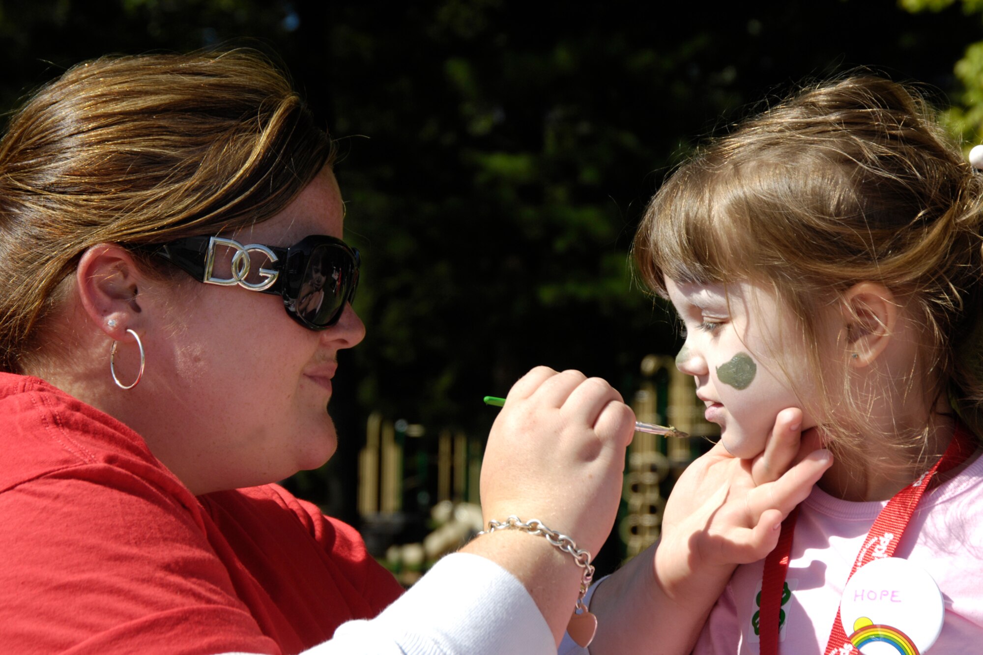 HANSCOM AFB, Mass. – Danielle Donohoe (left), 66th Services Squadron paints Hope Wheatley’s face on Sept. 20, during the Boys and Girls Club of America Day for Kids. The annual event included free food, crafts, games and activities for children. (U.S. Air Force photo by Linda LaBonte Britt)