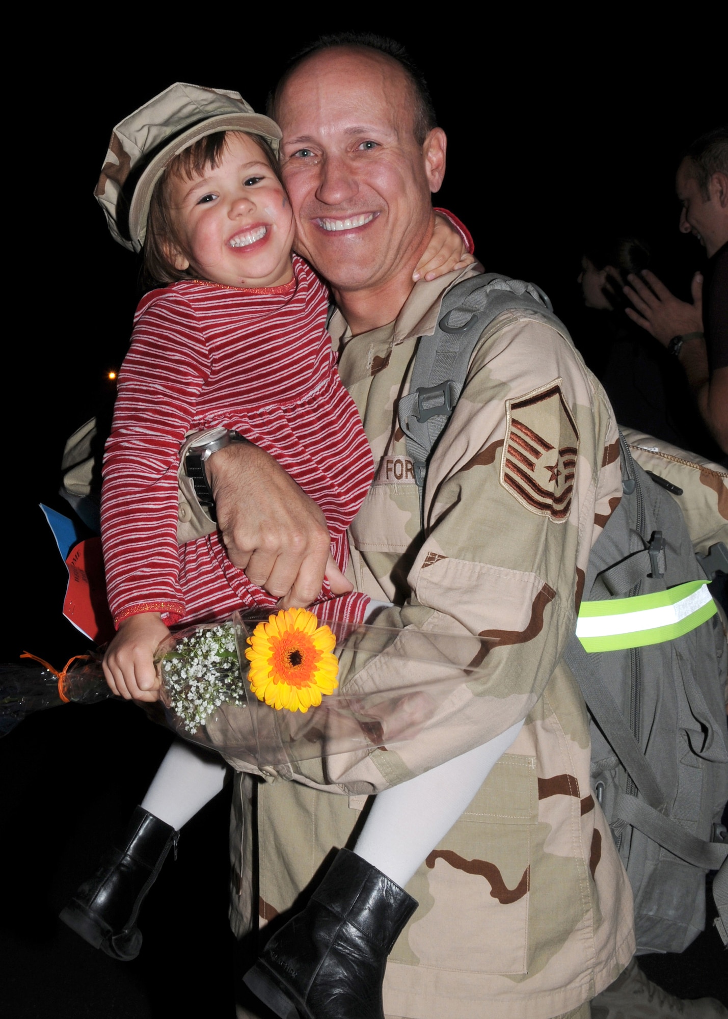 Master Sgt. Allan Kendrick, 606th Air Control Squadron, holds his daughter, Alexi, as he returns from a deployment to Southwest Asia in support of Operation Enduring Freedom Sept. 19, 2008. (U.S. Air Force photo by Staff Sgt. Heather M. Norris)