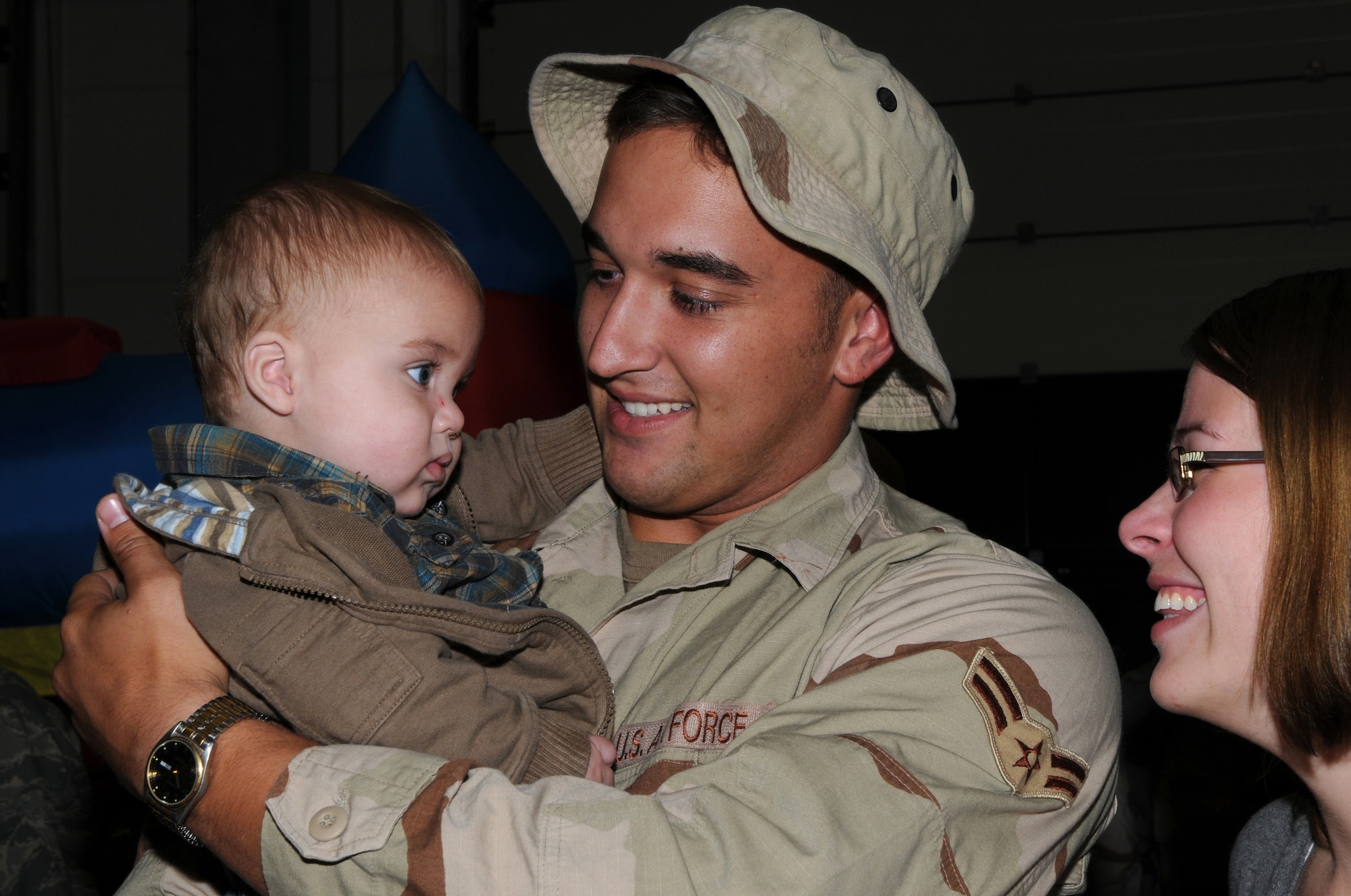 Airman 1st Class Nathan Sandberg, 606th Air Control Squadron, is met by his wife, Melissa, and 8-month-old son, Wes, as he returns from a deployment to Southwest Asia in support of Operation Enduring Freedom Sept. 19, 2008. (U.S. Air Force photo by Staff Sgt. Heather M. Norris)