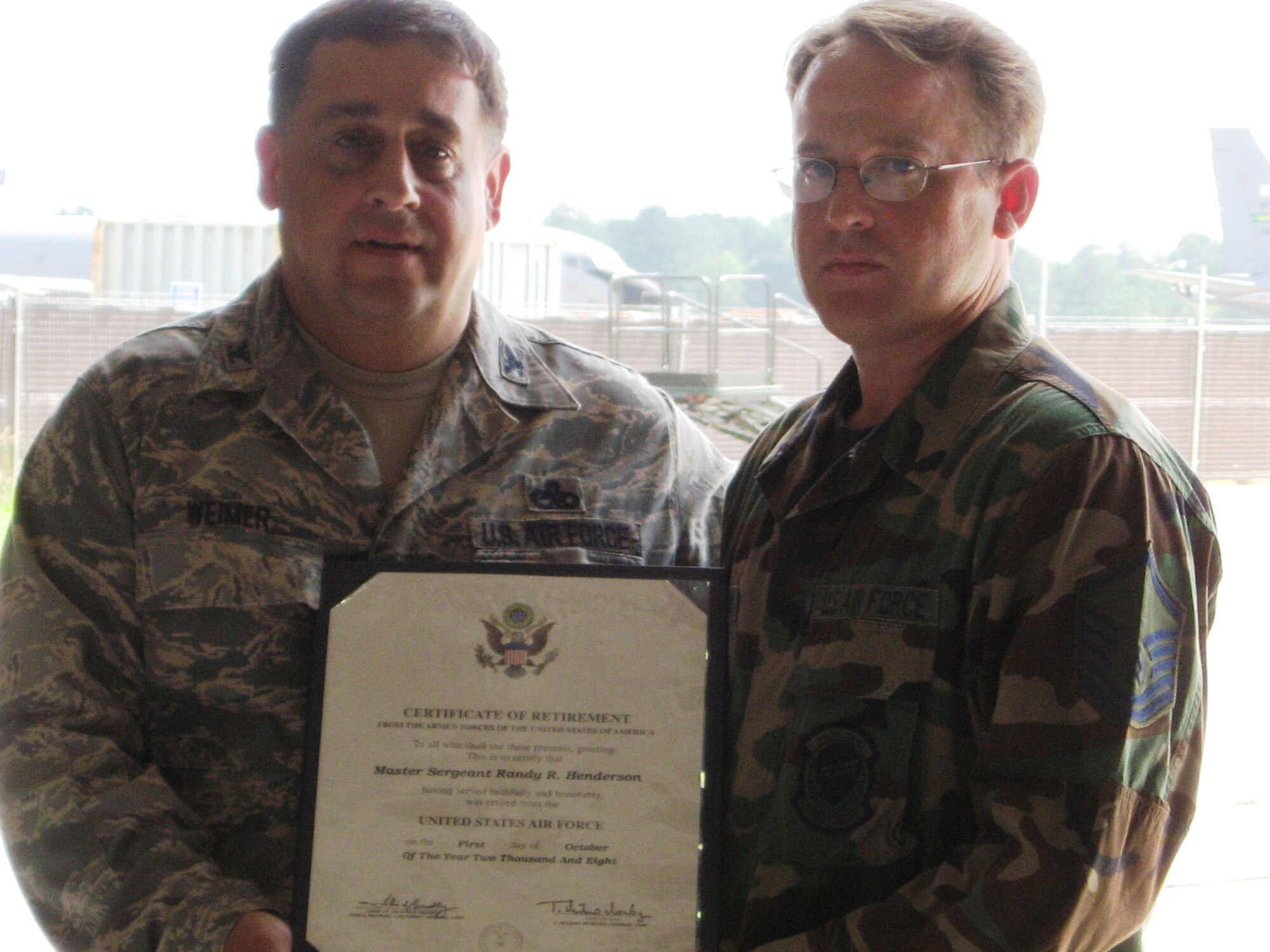 SEYMOUR JOHNSON AIR FORCE BASE, N.C. -- Master Sgt. Randy Henderson (right) receives his retirement certificate from Col. Paul Weimer, 916th Maintenance Group commander. Sgt. Henderson retired with more than 20 years service in September as a member of the 916th Aircraft Maintenance Squadron.