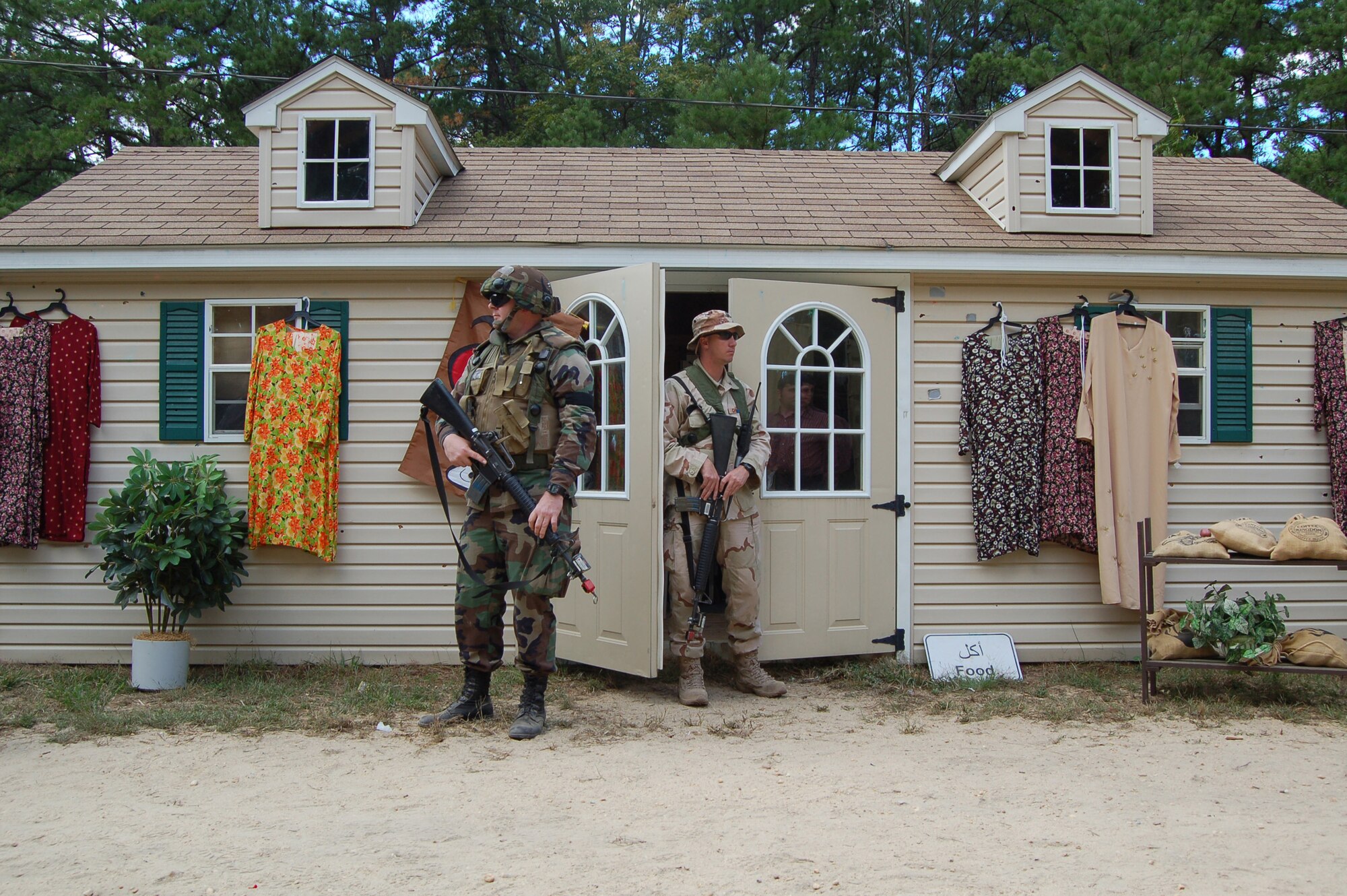 American and "host nation" forces guard a village cafe where they are hosting a joint meeting with the village chieftain during a scenario for Air Force Exercise Eagle Flag 08-6 Sept. 19, 2008, at Naval Air Engineering Station Lakehurst, N.J.. The exercise is managed by the U.S. Air Force Expeditionary Center's 421st Combat Training Squadron at Fort Dix, N.J., and tests and trains Airmen in expeditionary combat support skills. (U.S. Air Force Photo/Senior Airman Julius Delos Reyes)