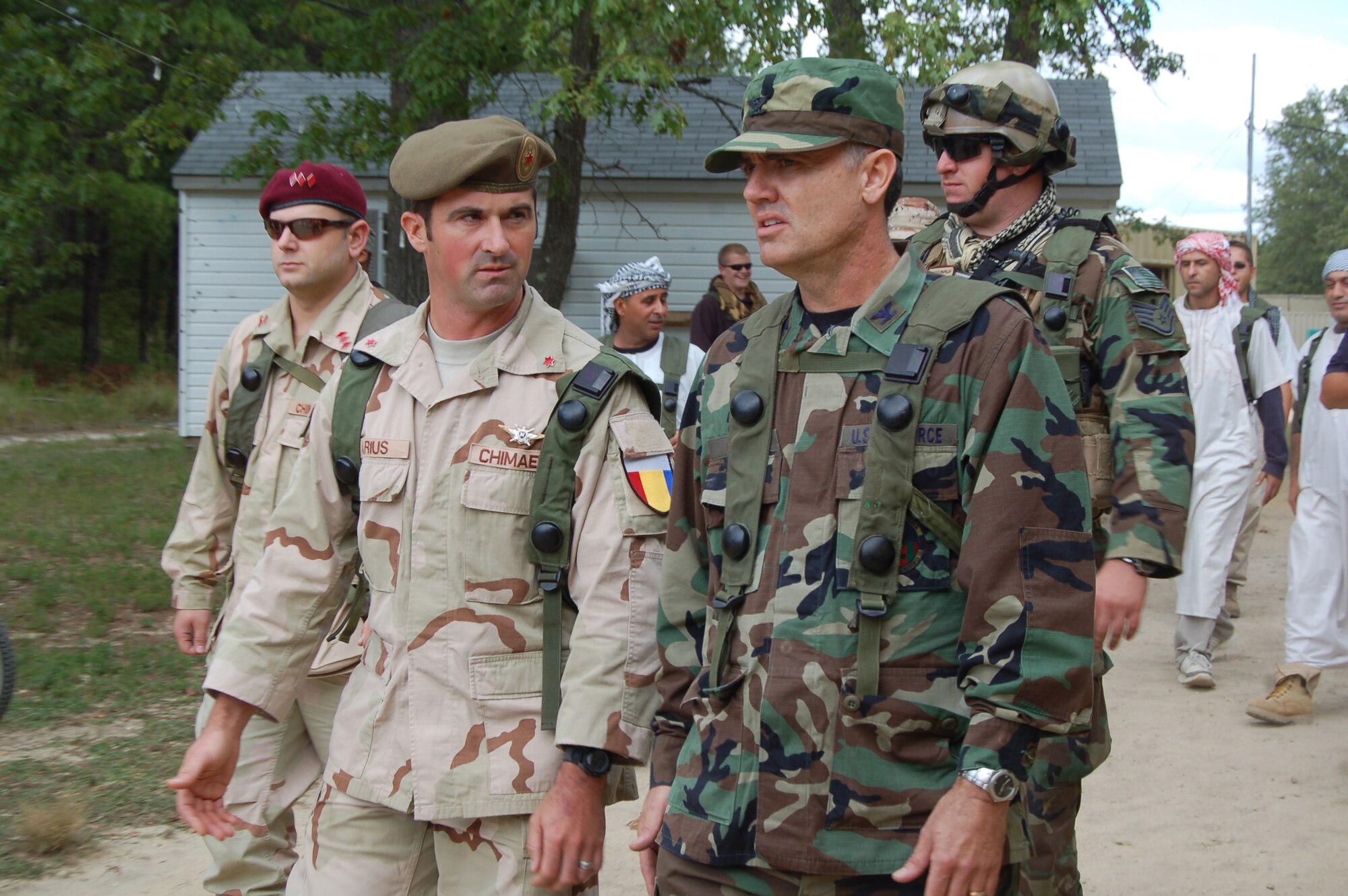 A 421st Combat Training Squadron cadre member playing the host nation commander role of "Colonel Marius," walks with Col. Darryl Riggs, 95th Mission Support Group commander from Edwards Air Force Base, Calif.,  as they participate in a scenario for Air Force Exercise Eagle Flag 08-6 Sept. 19, 2008, at Naval Air Engineering Station Lakehurst, N.J. The exercise is managed by the U.S. Air Force Expeditionary Center's 421st CTS at Fort Dix, N.J., and tests and trains Airmen in expeditionary combat support skills.  (U.S. Air Force Photo/Senior Airman Julius Delos Reyes)