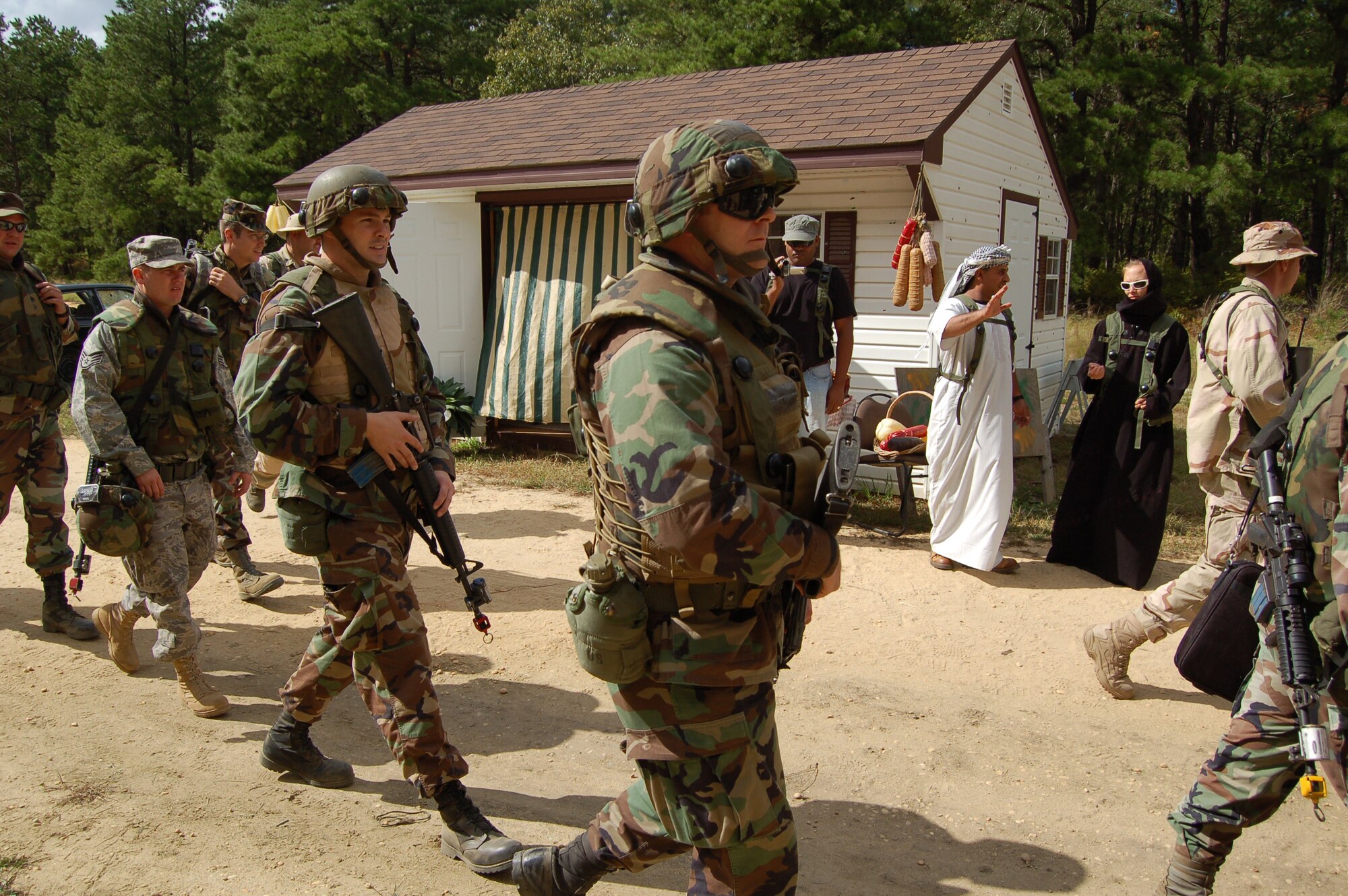 Airmen arrive at  the "village" Sept. 19, 2008, as part of a scenioo for Air Force Exercise Eagle Flag 08-6.  The combat exercise is held at Naval Air Engineering Station Lakehurst, N.J., where participants demonstrate the capability to open an air base in an austere location. (U.S. Air Force Photo/Senior Airman Julius Delos Reyes)