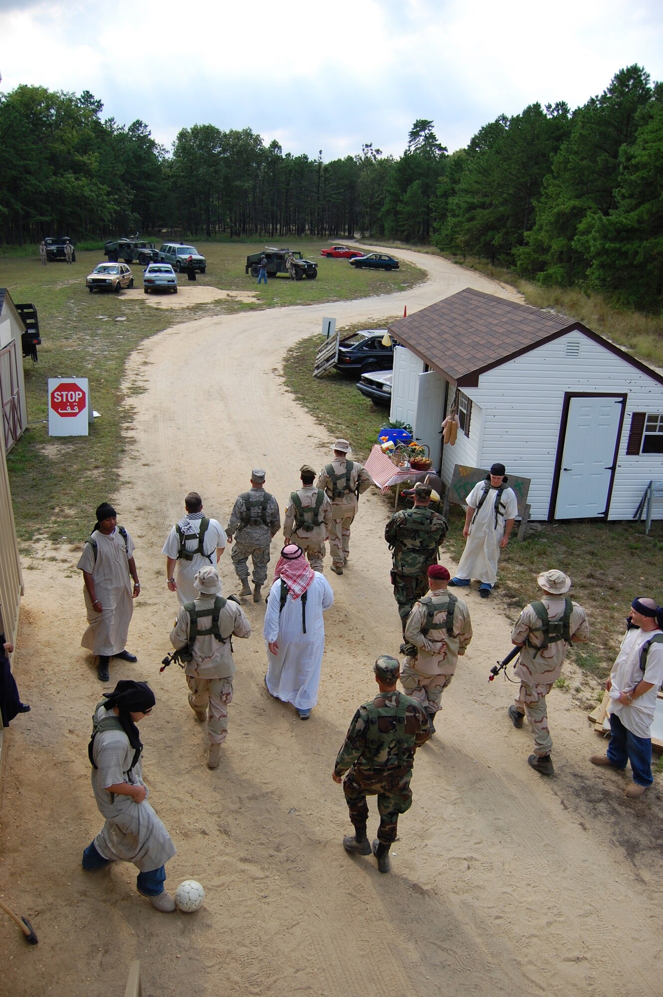 Role players and participants stroll through the fictional village of "Citheron" during a scenario for Air Force Exercise Eagle Flag 08-6 Sept. 18, 2008, at Naval Air Engineering Station Lakehurst, N.J.  Eagle Flag is operated by the U.S. Air Force Expeditionary Center's 421st Combat Training Squadron at Fort Dix, N.J. The purpose of Eagle Flag is to test and train Airmen in expeditionary combat support skills. (U.S. Air Force Force photo/Staff Sgt. Desiree N. Palacios) 