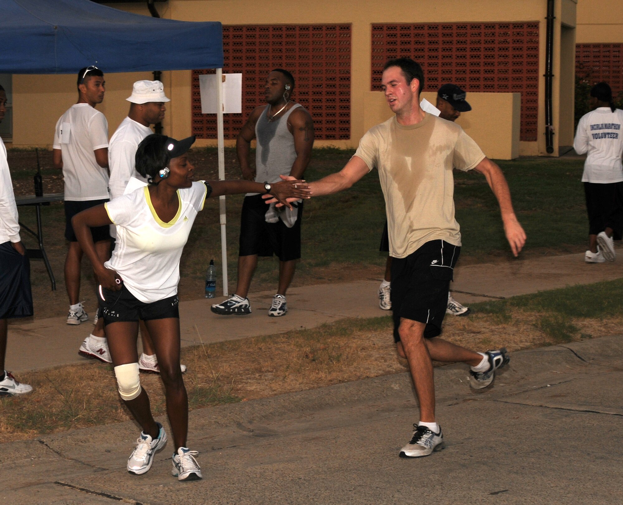 Relay team members change off during the Incirlik 1/2 Marathon Sept. 20. The event not only included a 13.1-mile run, but also a four-person relay and a 5K walk. (U.S. Air Force photo by Senior Airman Heather Stanton)